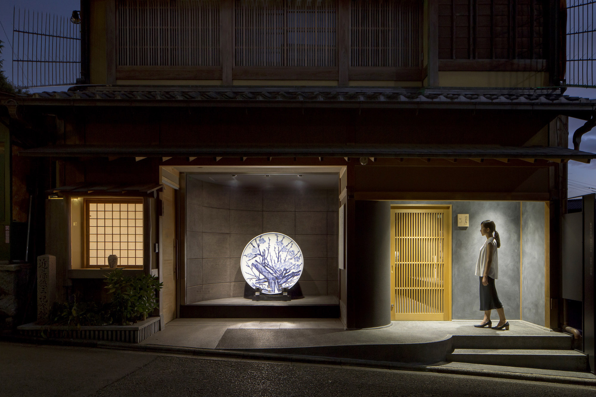 Kondo Museum in Kyoto by Mamiya Shinichi Design Studio — The ground-floor gallery elevation presents three distinct spatial zones at dusk.