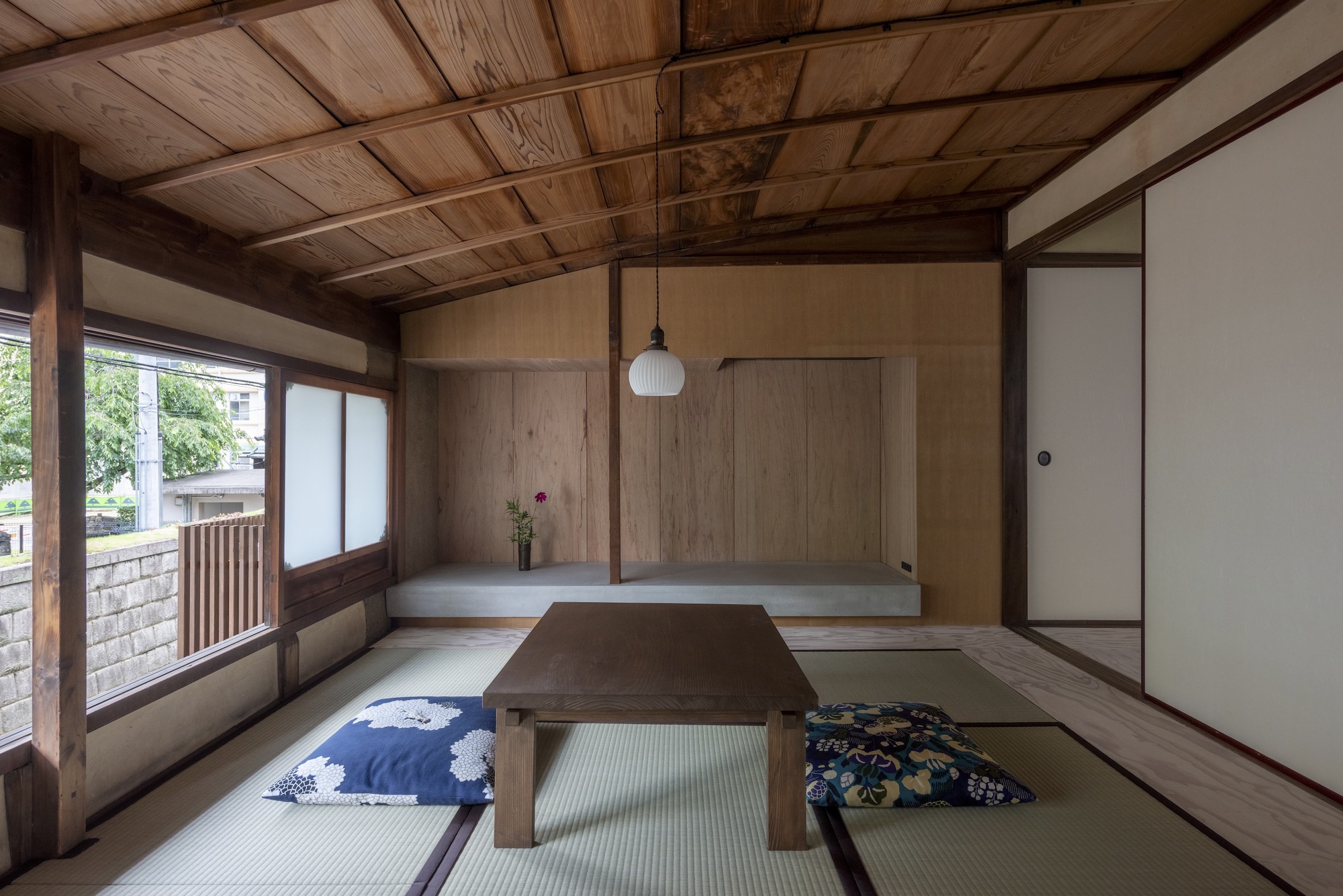 Kawamichiya Kosho-An Restaurant by td-Atelier + Endo Shorijo Design by td-Atelier and Endo Shorijo Design — A post-and-beam timber-framed dining room within the restored 110-year-old townhouse features a central wooden table positioned on tatami matting.