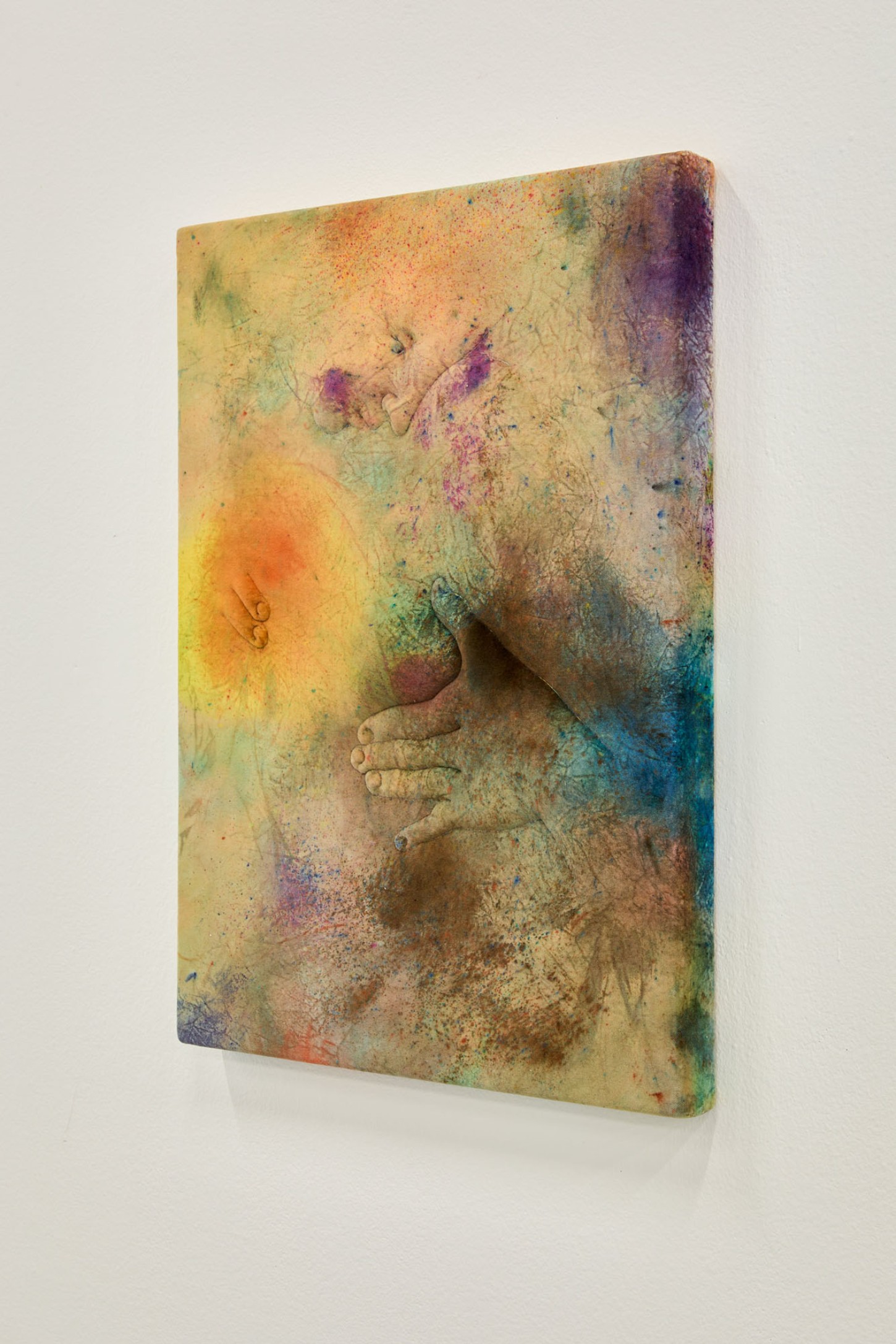 Thirst by Eliška Konečná at Polansky — A carved sandstone relief depicting intertwined human figures in varying states of repose, their bodies emerging volumetrically from the weathered stone ground.