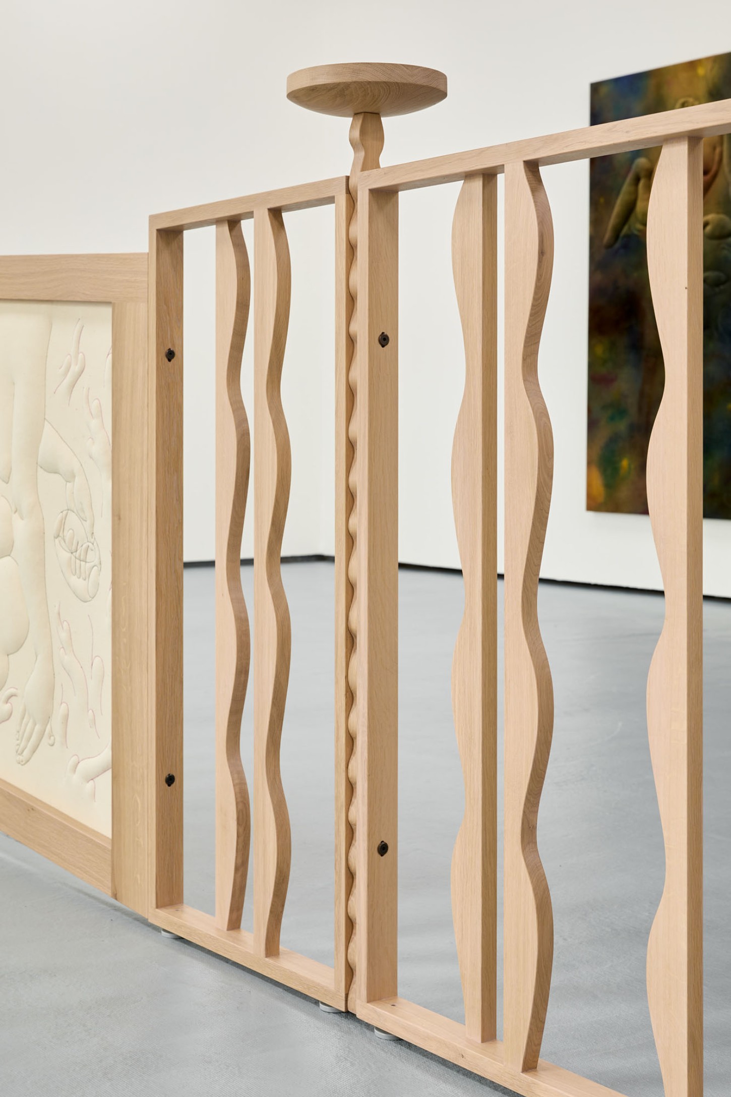 Thirst by Eliška Konečná at Polansky — Wooden balustrade featuring hand-carved spindles with undulating, organic profiles that create rhythmic visual movement across the horizontal rail.