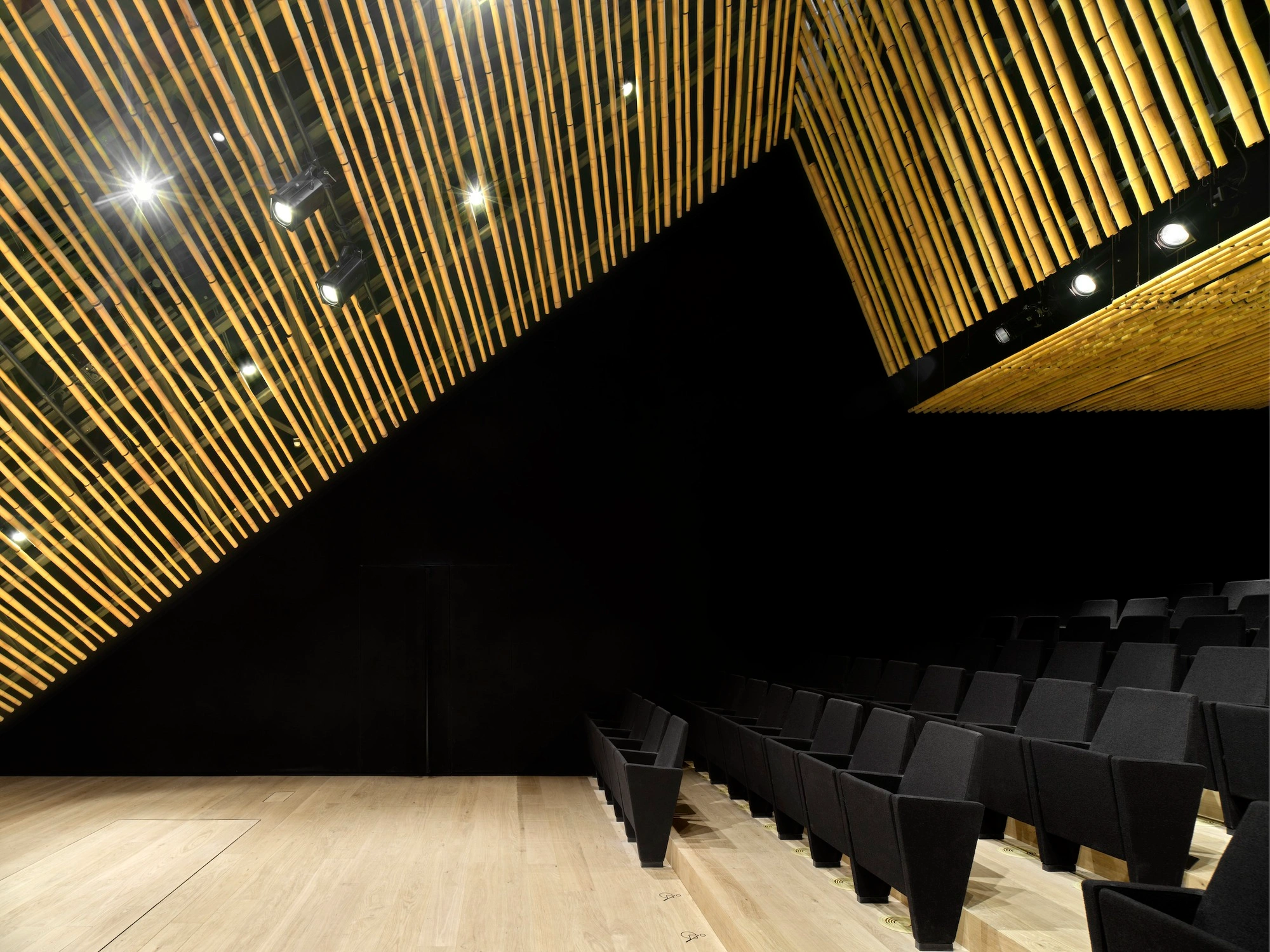Albert Kahn Museum by Kengo Kuma & Associates — An interior view of the auditorium reveals the museum's architectural centerpiece: continuous horizontal aluminum striations wrap the curved ceiling,...