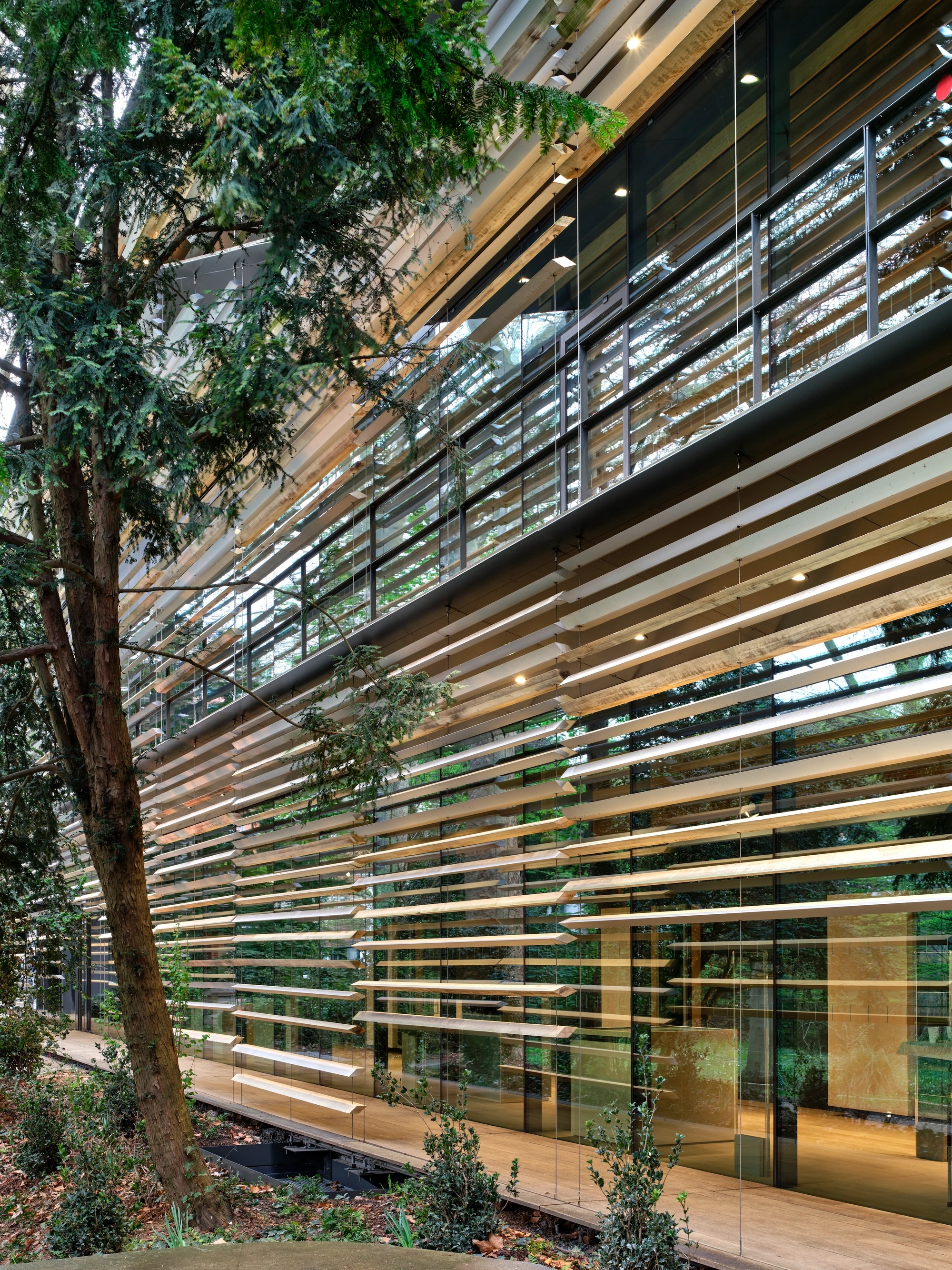Albert Kahn Museum by Kengo Kuma & Associates — The curved facade demonstrates Kengo Kuma's signature material language through continuous horizontal aluminum striations that wrap around the building's...