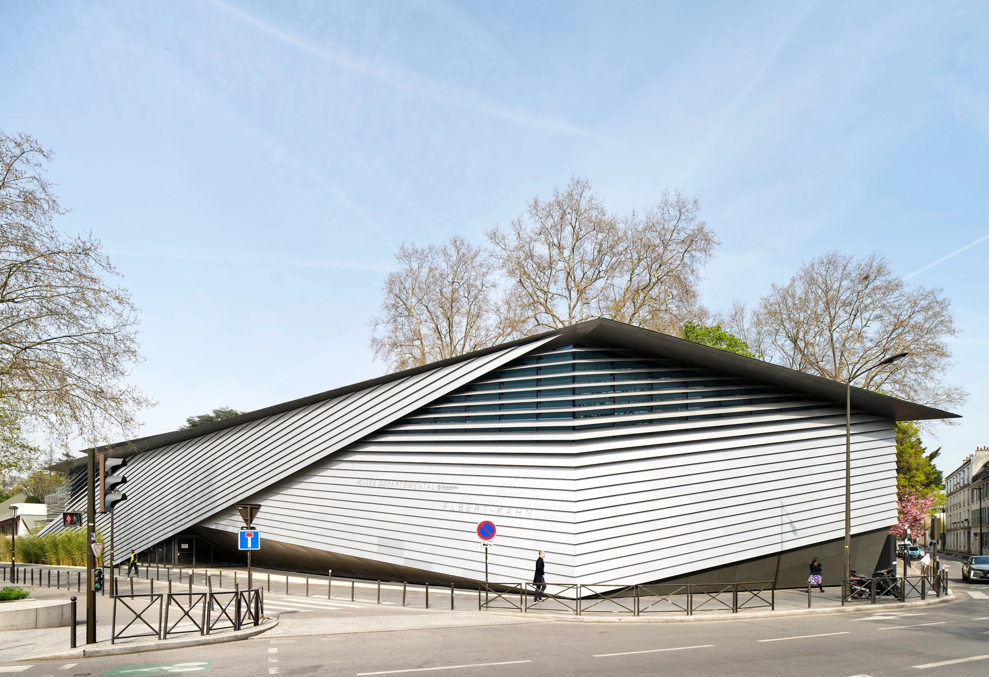 Albert Kahn Museum by Kengo Kuma & Associates — The Albert Kahn Museum presents its primary facade as a continuous composition of horizontal aluminum striations wrapping a curved, undulating form that...