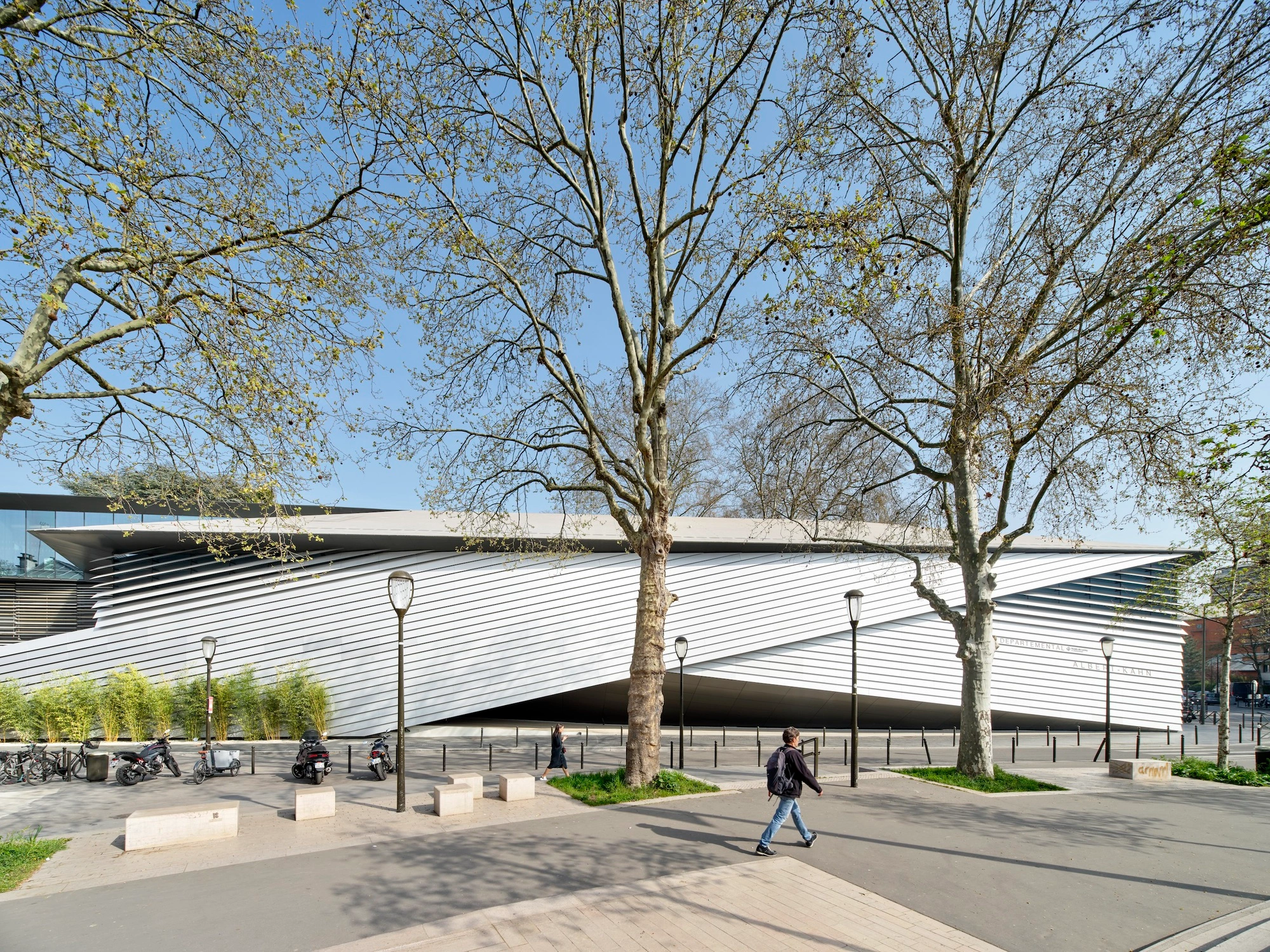 Albert Kahn Museum by Kengo Kuma & Associates — The Albert Kahn Museum presents itself as a horizontal datum across the plaza, its curved facade clad entirely in continuous aluminum striations that...