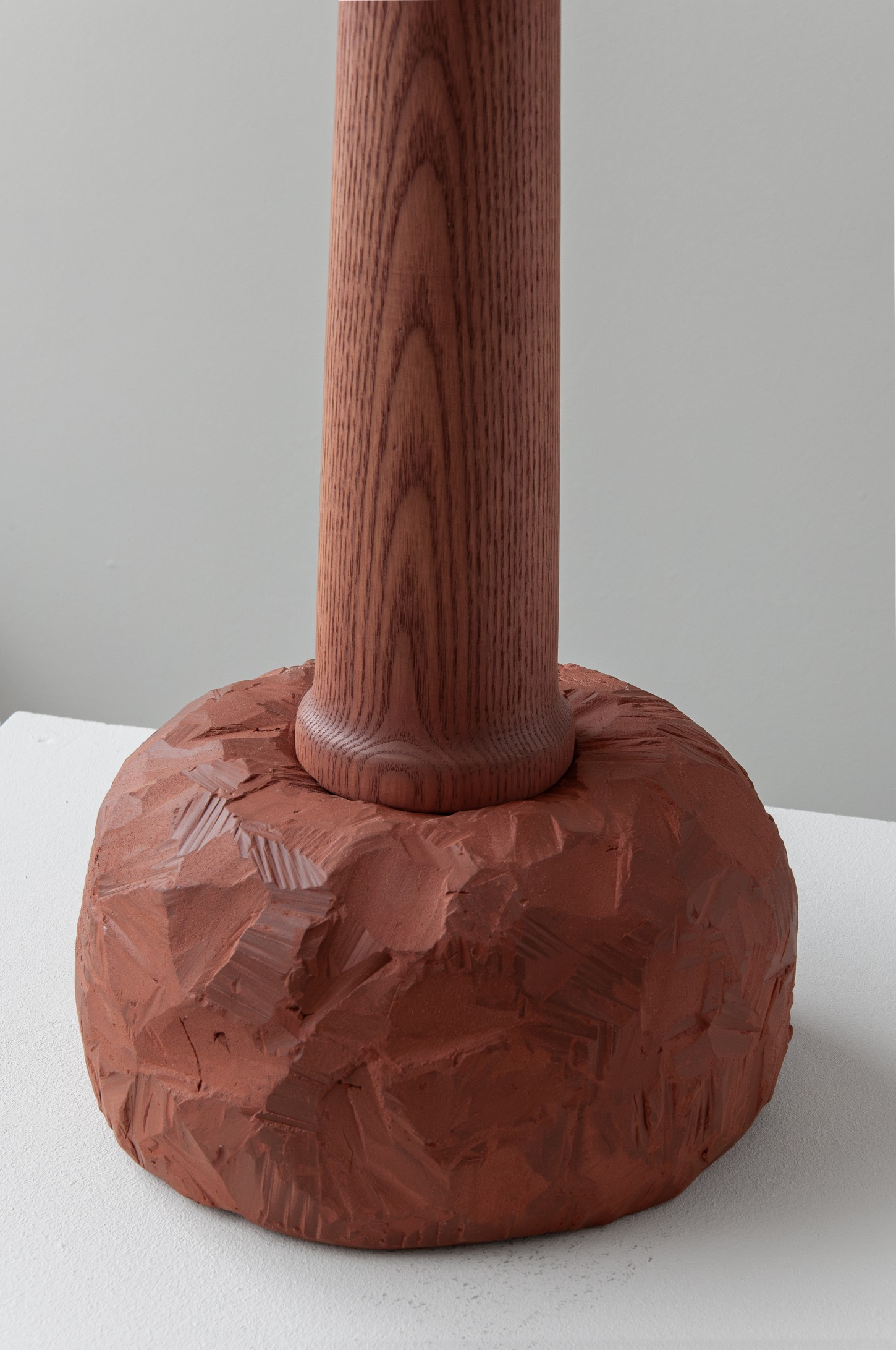 'Burn & Turn' by Adrian Bursell + Siri Svedborg — Turned wooden pedestal with pronounced vertical fluting rises from a hand-cast terracotta base in the work 'Burn & Turn' by Adrian Bursell and Siri Svedborg.