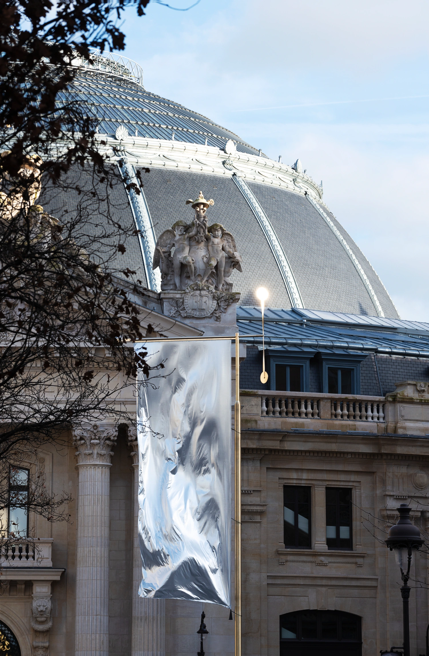 Paris' La Bourse de Commerce redesigned by Tadao Ando — A monolithic concrete cylinder rises through the historic rotunda of La Bourse de Commerce, its perforated light-grey surface creating a stark volumetric...