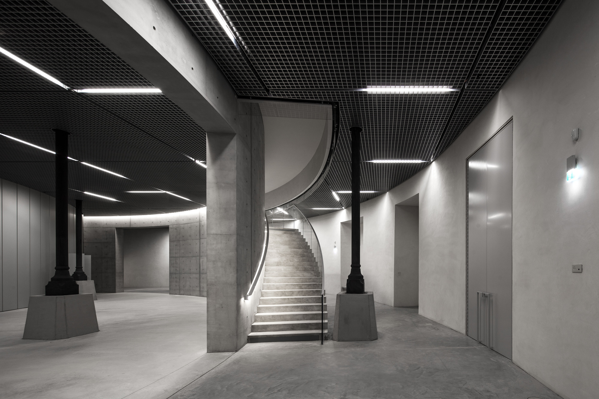 Paris' La Bourse de Commerce redesigned by Tadao Ando — A monolithic concrete cylinder, board-formed and measuring 9 meters in height, dominates the central void of the historic rotunda.