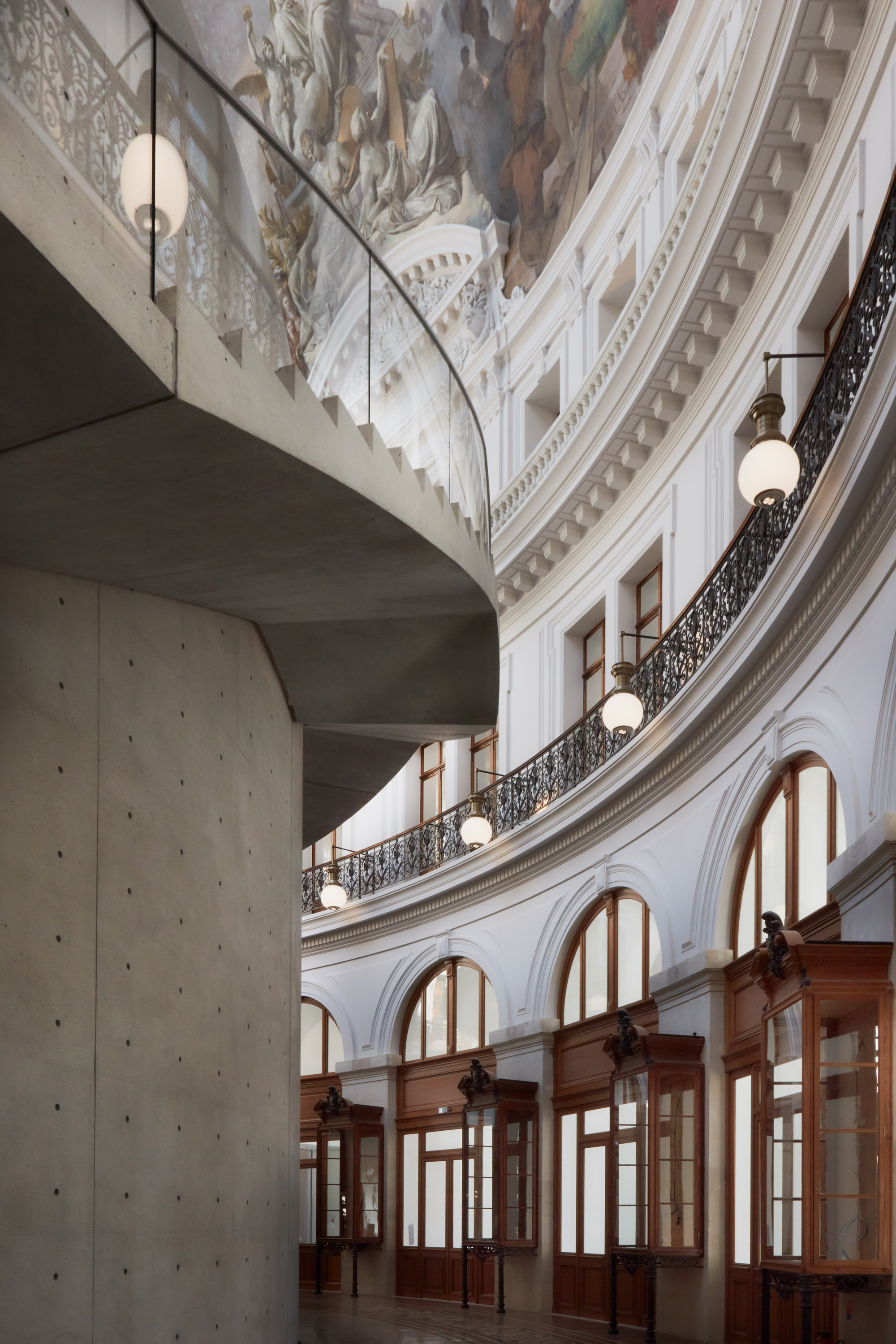 Paris' La Bourse de Commerce redesigned by Tadao Ando — A monolithic concrete cylinder, board-formed and perforated with regular circular apertures, rises nine meters within the historic rotunda.