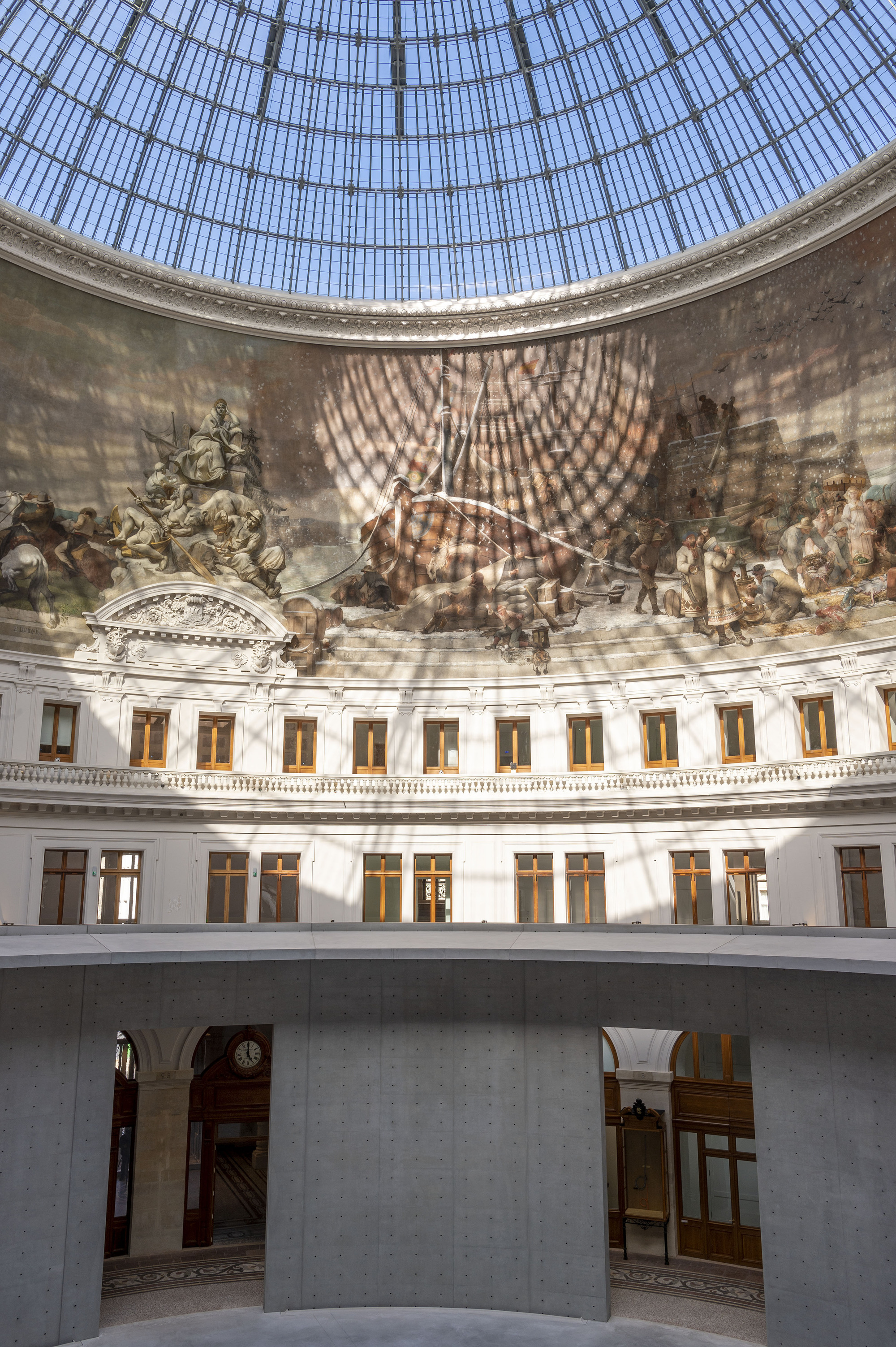 Paris' La Bourse de Commerce redesigned by Tadao Ando — The rotunda's interior is bisected by a 9-meter perforated light-grey concrete cylinder that rises through the void, its geometric form contrasting sharply...