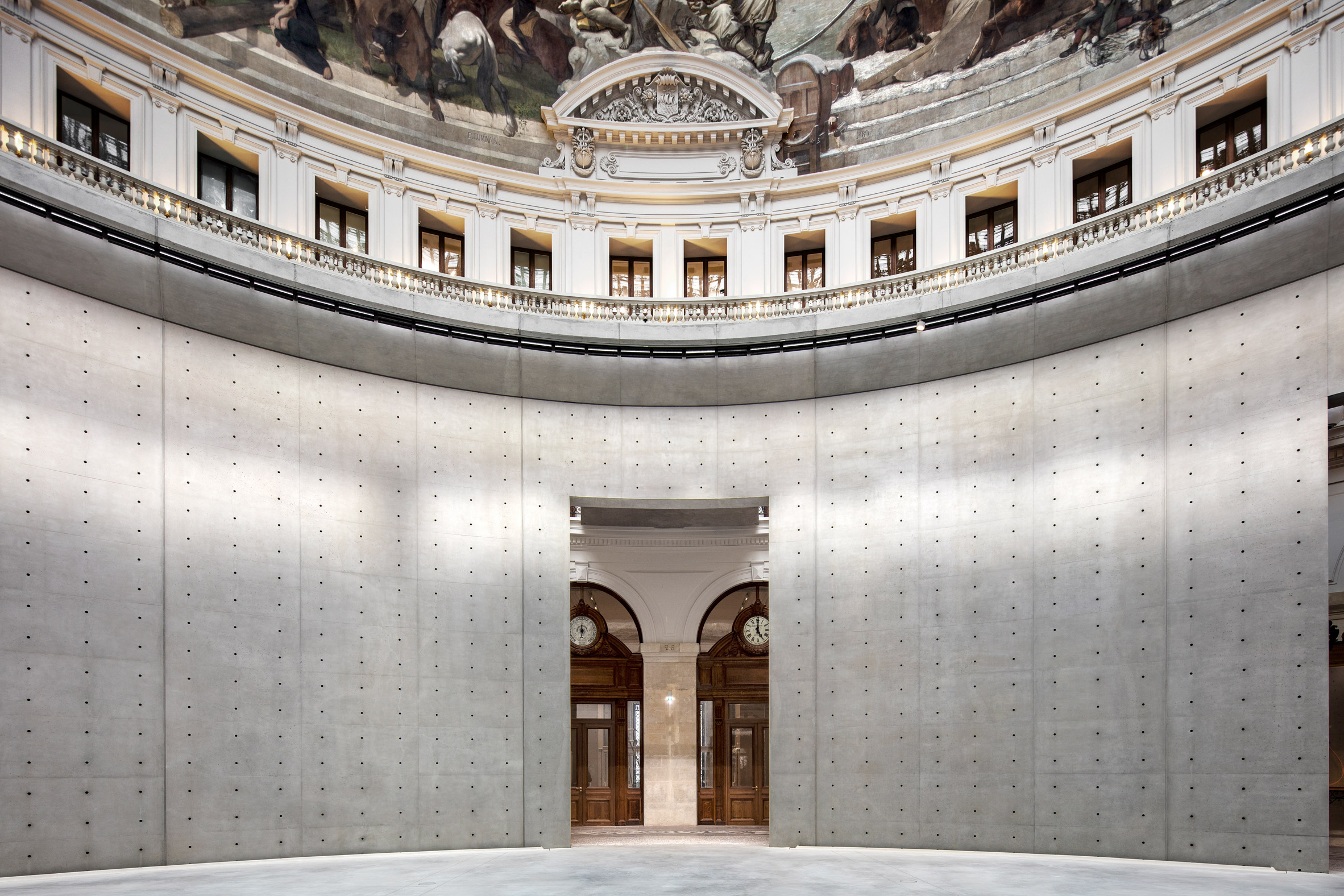 Paris' La Bourse de Commerce redesigned by Tadao Ando — A monolithic perforated concrete cylinder, nine meters tall, occupies the central void of the historic rotunda.
