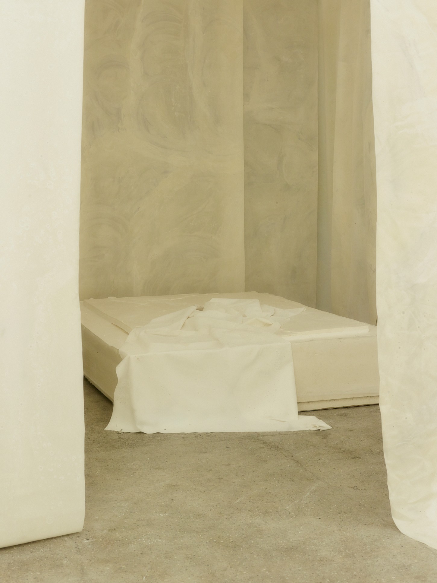 'White Utopia' by Natural Material Studio — A sculptural bioplastic bathtub occupies a niche-like alcove within the bedroom installation.