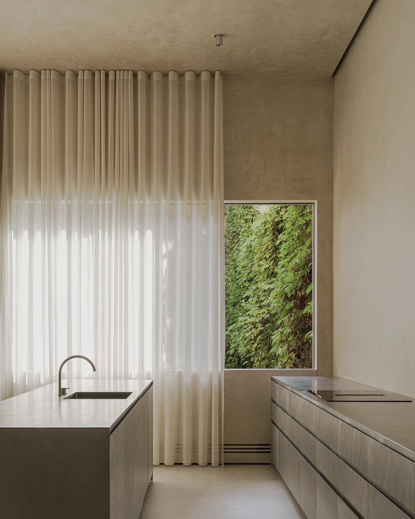 ZØ Residence by Studio Beta Ø — A galley kitchen captured from the threshold, revealing the spatial compression of this linear plan.