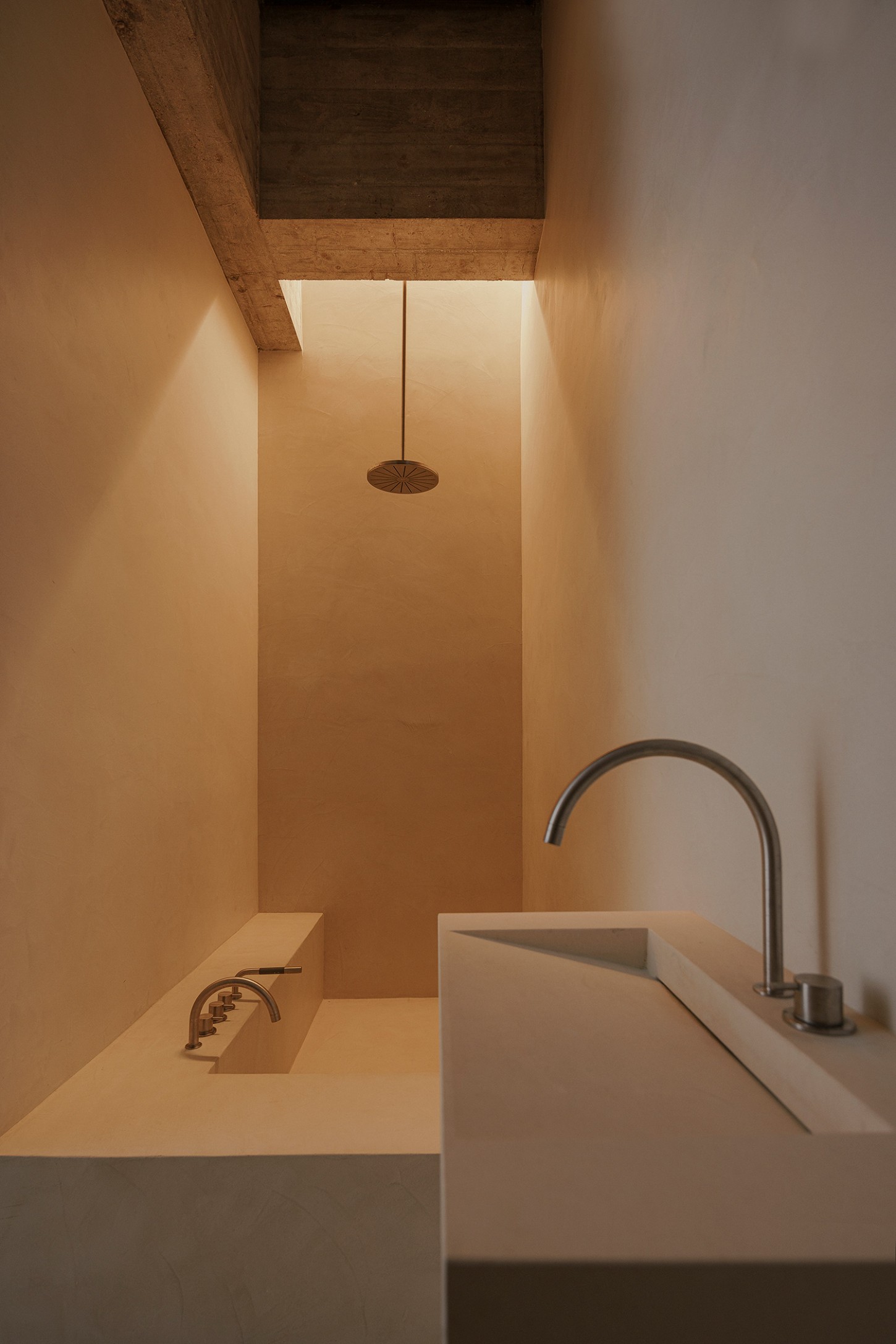 ZØ Residence by Studio Beta Ø — A narrow bathroom passage framed by warm terracotta-rendered walls and a dark timber soffit overhead.