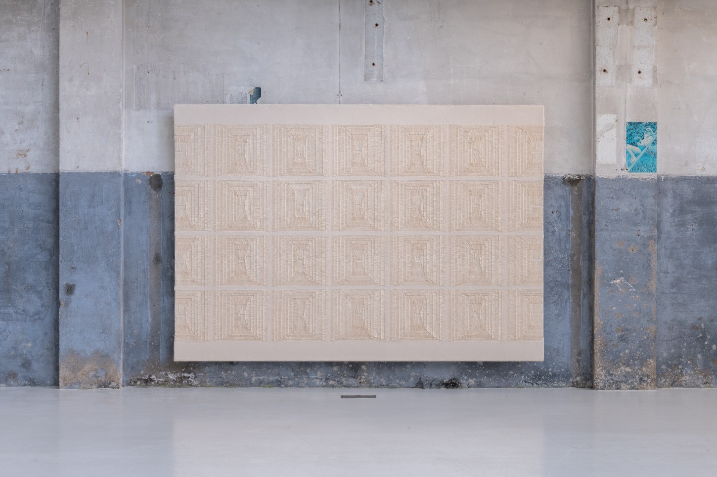 'Repetition is a Form of Change' by Sophie Rowley at Looiersgracht 60 — Rowley's textile work presents a grid of 120 woven rectangular units arranged in twelve rows, each displaying fine linear patterns in warm beige across...