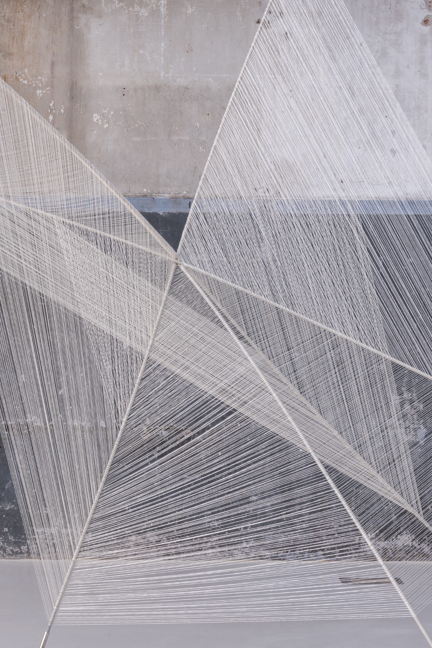 'Repetition is a Form of Change' by Sophie Rowley at Looiersgracht 60 — A close-up view of Sophie Rowley's woven textile work reveals the artist's meticulous hand-crafted process.