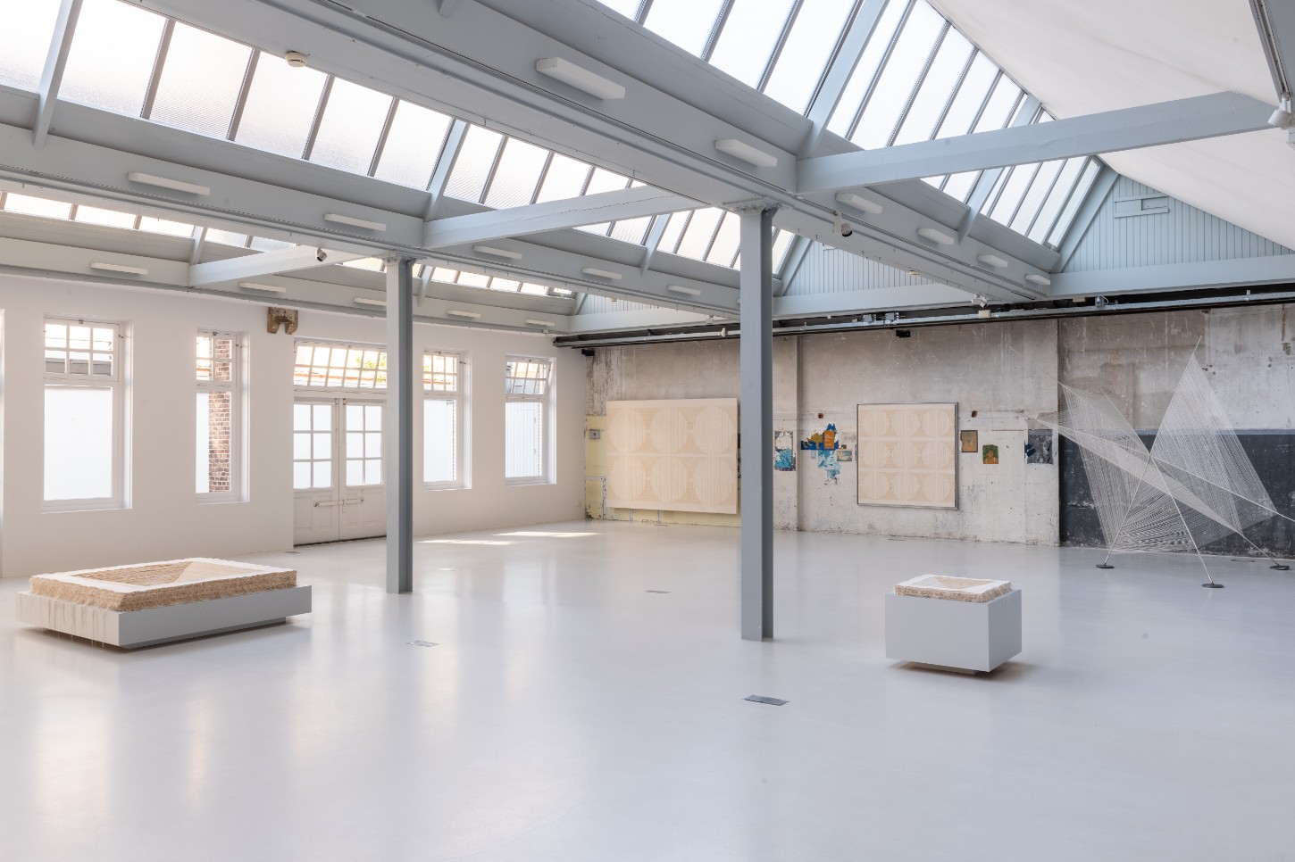 'Repetition is a Form of Change' by Sophie Rowley at Looiersgracht 60 — Sophie Rowley's installation occupies a converted industrial space with clerestory skylights and exposed structural steel beams.