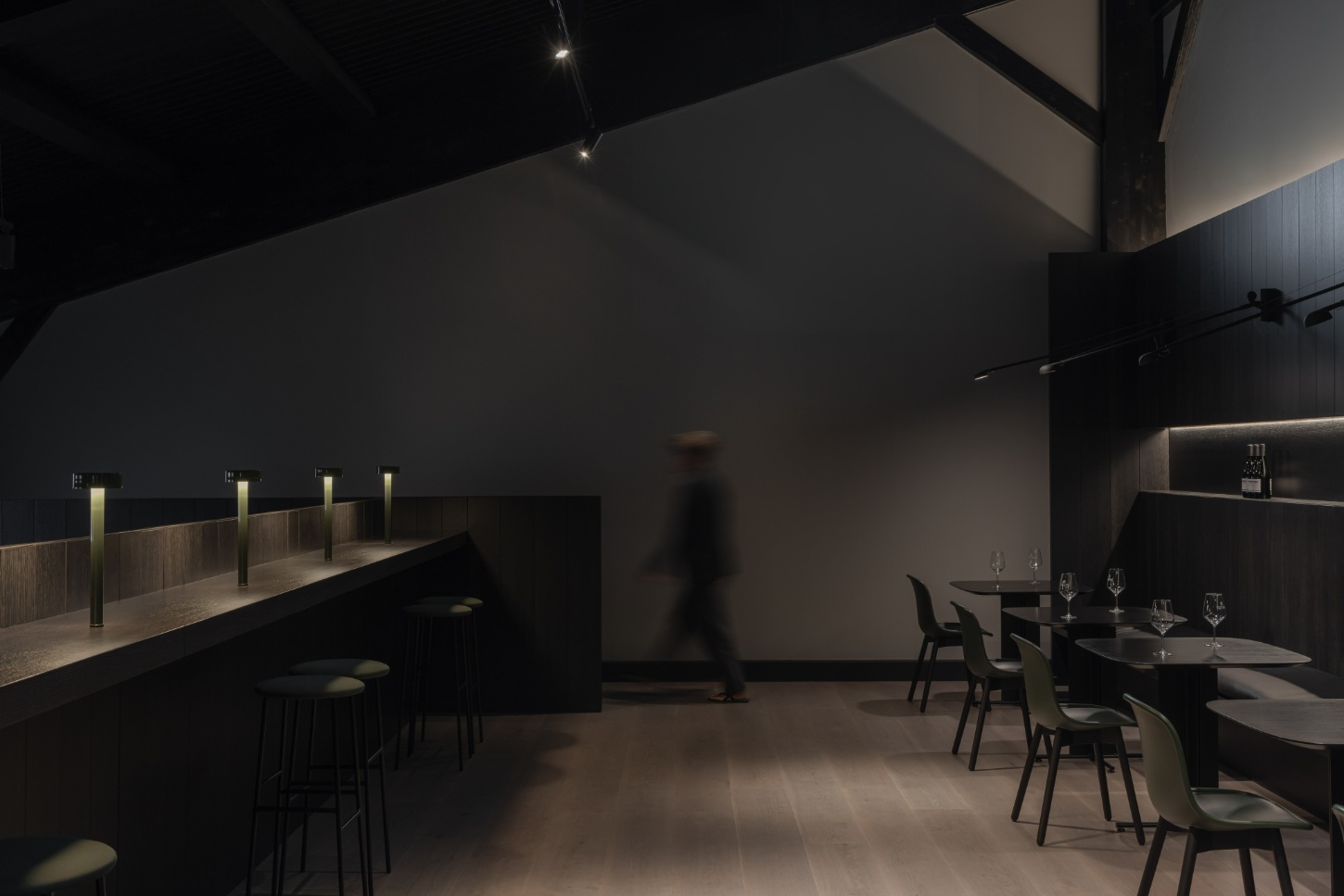 Tritium Winery by Francesc Rifé Studio — A tasting room interior demonstrates restrained material expression through charred timber cladding and blackened steel furnishings.
