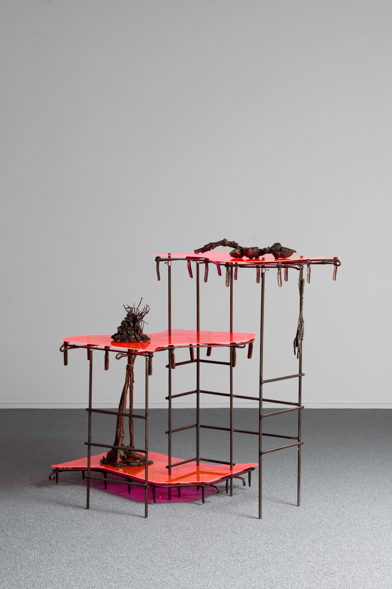 Bleak Harvest by Anna Bak at Vestjyllands Kunstpavillon — A three-tiered sculptural structure constructed from rusted metal framework supporting neon-pink and magenta platforms.