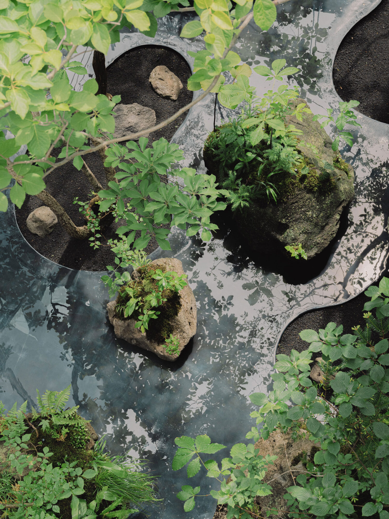 Arc’teryx Tokyo Creation Center by Torafu Architects — Overhead view of the Arc'teryx Tokyo courtyard reveals the 'Outside In' concept materially embedded.