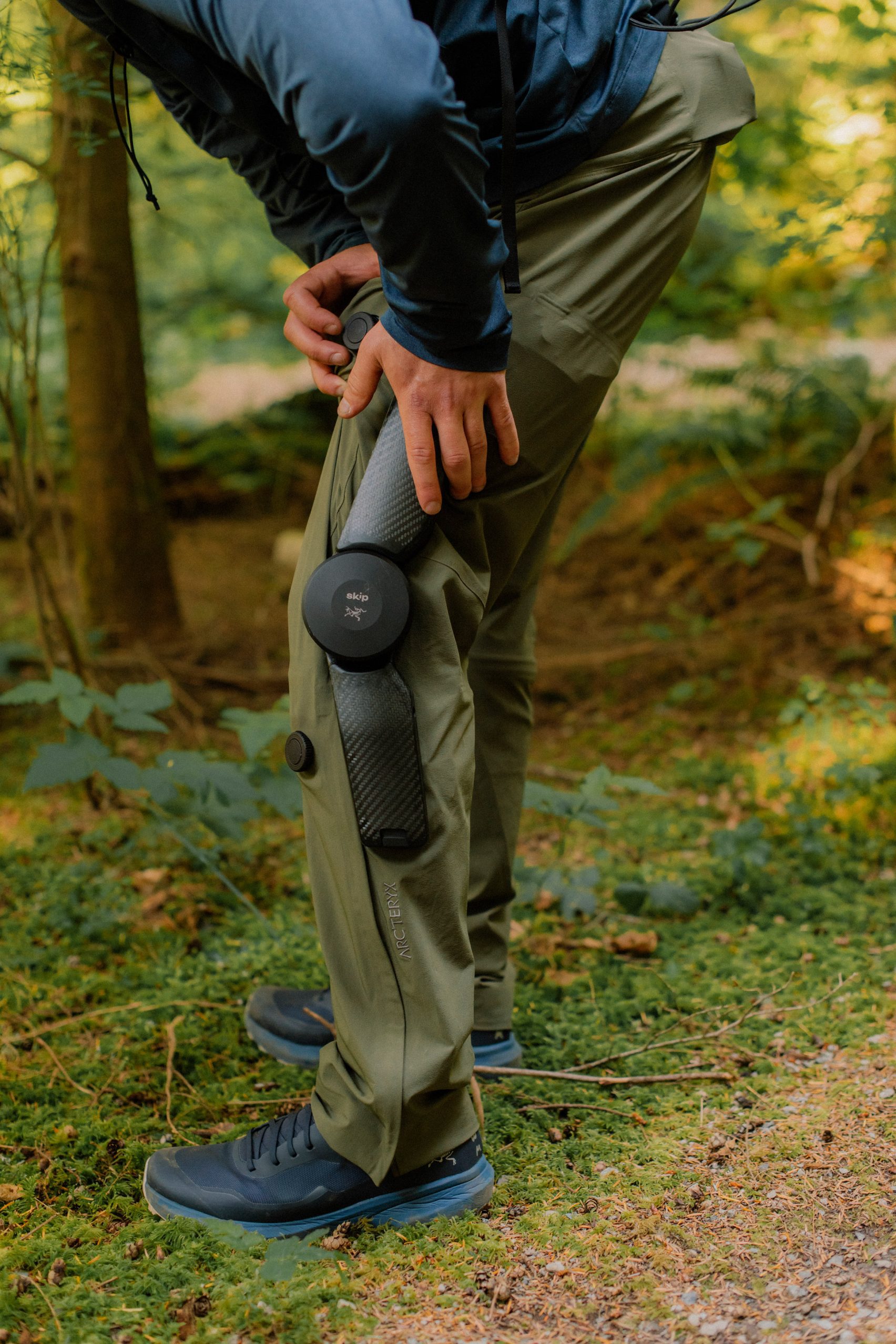 MO/GO Pants with Exoskeleton by Arc'teryx + Skip — Detail shot of the MO/GO exoskeleton trousers emphasizing the motorized knee joint and carbon fiber bracing system.