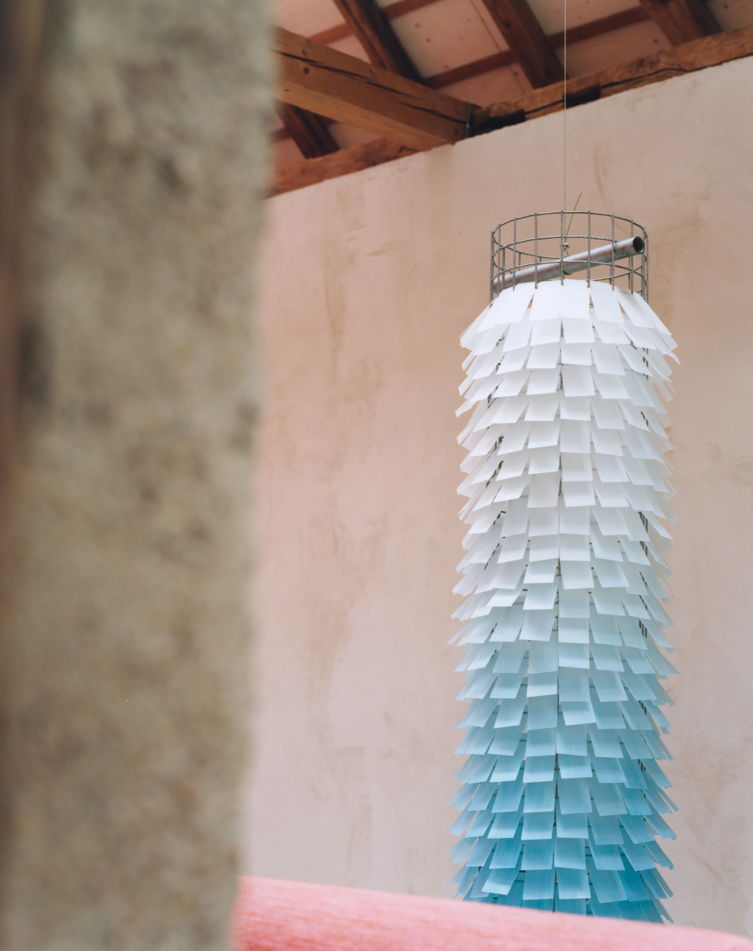Erika and Willi's Barn by Piertzovanis Toews — A pendant light fixture dominates the frame, suspended from the exposed timber ceiling.