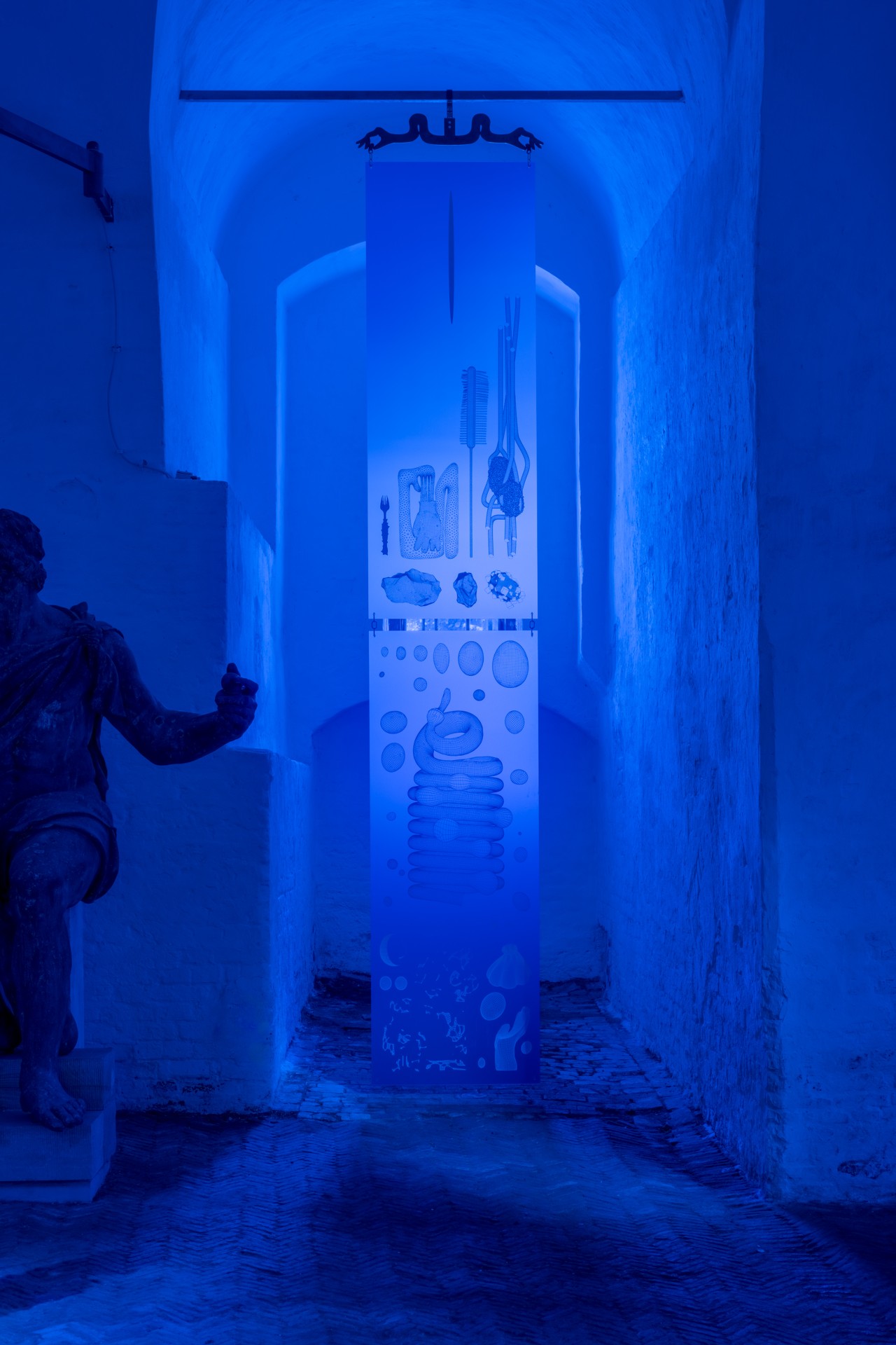 Techno Mythologies by Wang & Söderström at Christian IV’s Brewery — A narrow corridor bathed in saturated blue lighting frames an immersive installation at Christian IV's Brewery.