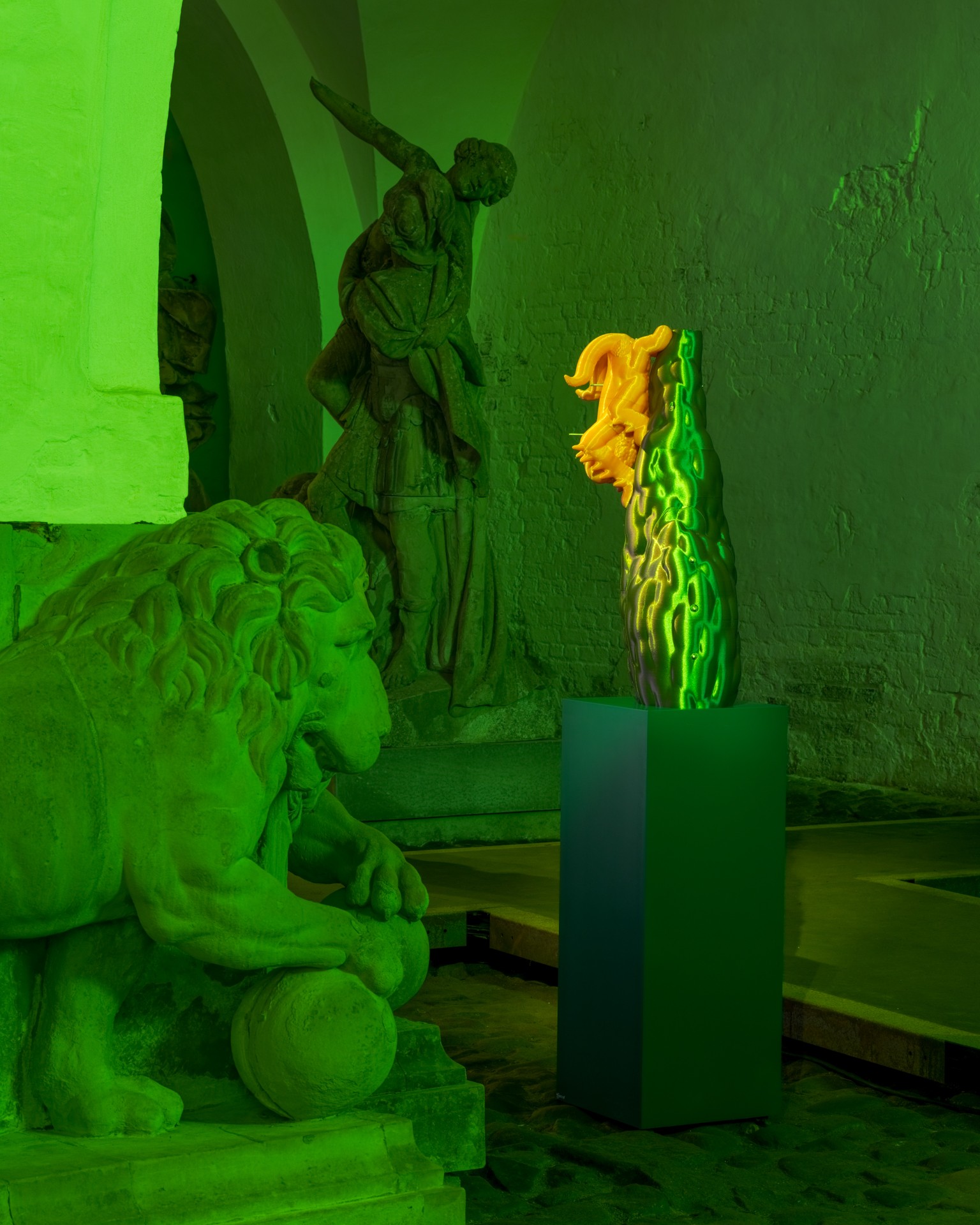 Techno Mythologies by Wang & Söderström at Christian IV’s Brewery — A cactus-form ceramic sculpture with textured surface and vibrant yellow-orange flower bloom sits elevated on a dark green cubic plinth, positioned as the...