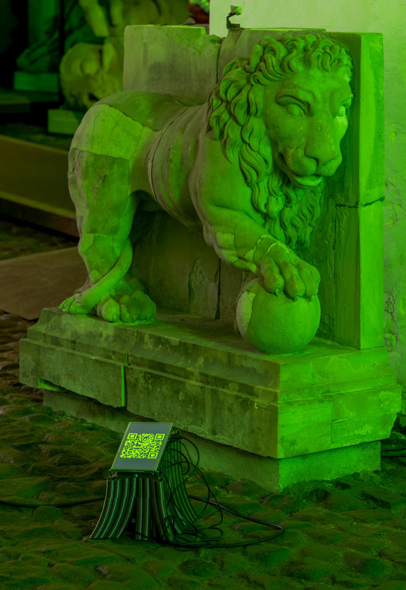 Techno Mythologies by Wang & Söderström at Christian IV’s Brewery — A classical lion sculpture rendered in saturated lime-green monochromatic light sits elevated on a dark green cubic plinth within Christian IV's Brewery.