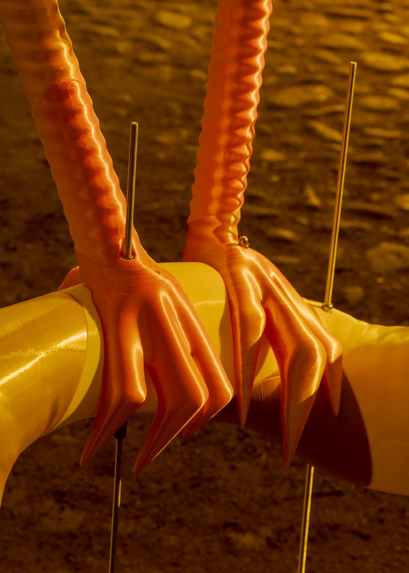 Techno Mythologies by Wang & Söderström at Christian IV’s Brewery — Ceramic sculptural forms with ribbed vertical surfaces in orange and yellow tones emerge from yellow cylindrical bases, anchored by thin brass rods against...