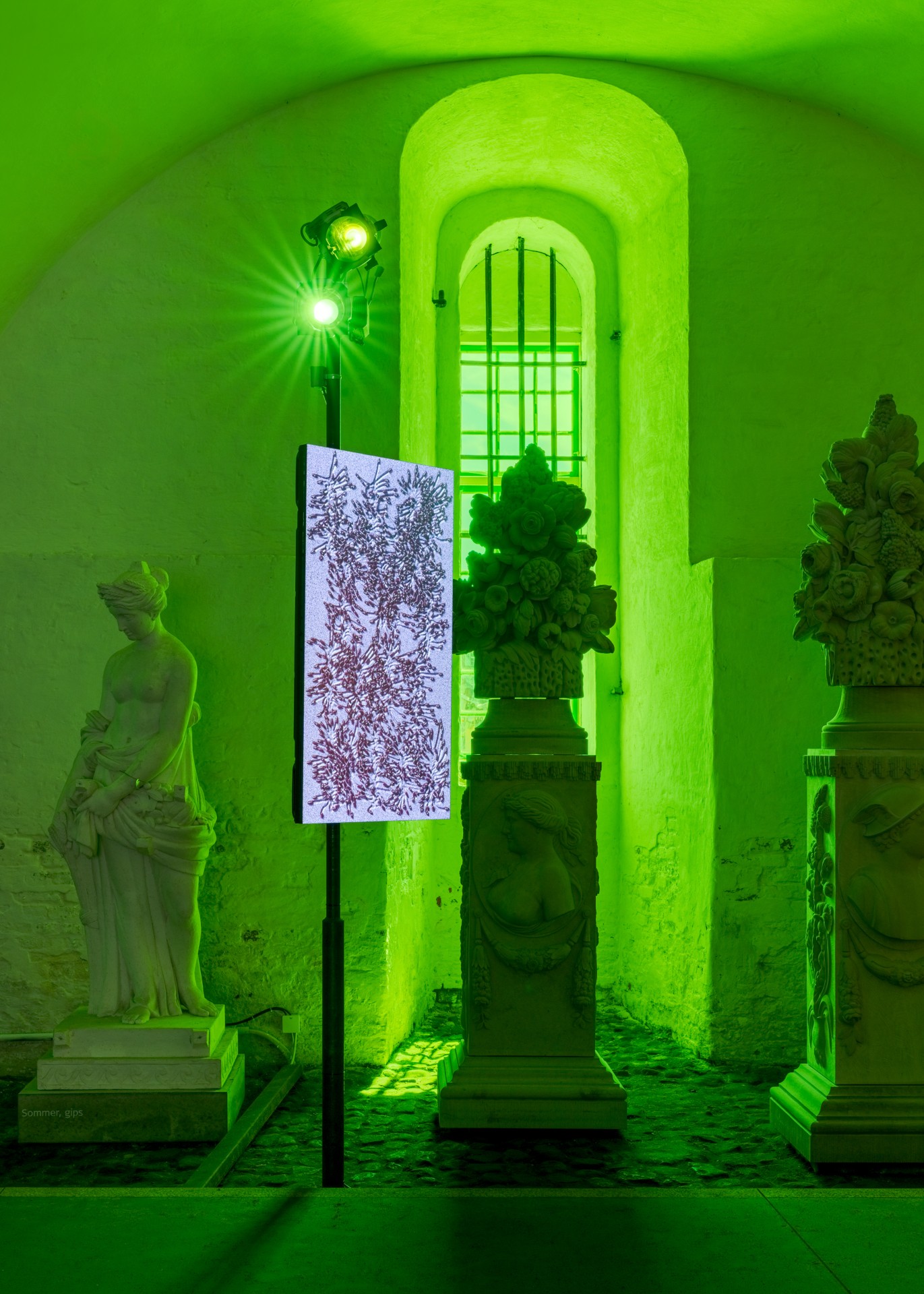 Techno Mythologies by Wang & Söderström at Christian IV’s Brewery — A gallery corridor flooded with saturated lime-green neon lighting reveals a temporal layering of classical and contemporary forms.