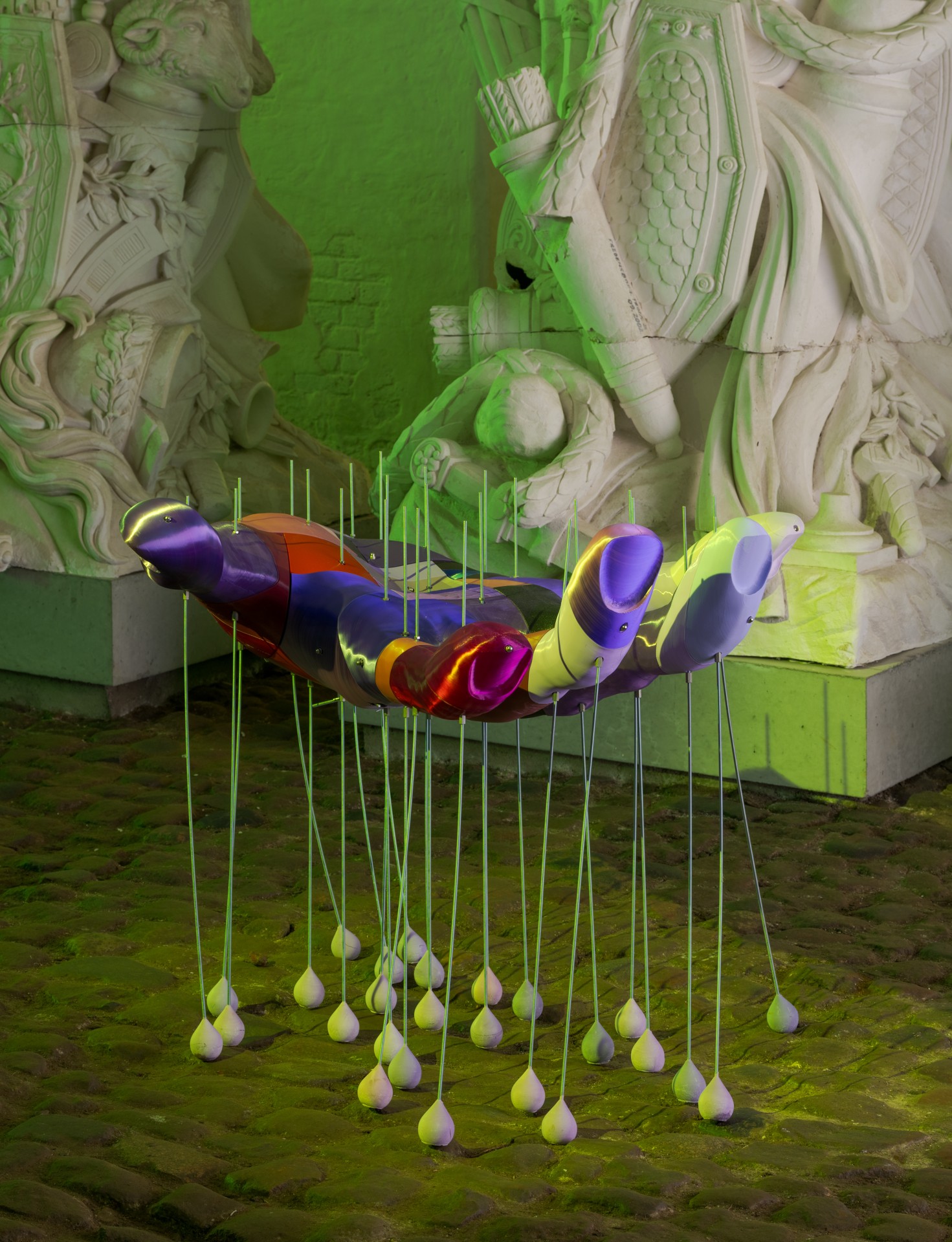 Techno Mythologies by Wang & Söderström at Christian IV’s Brewery — A sculptural installation suspended within a lime-green monochromatic gallery space, featuring a segmented form with prismatic surfaces in purple, magenta,...