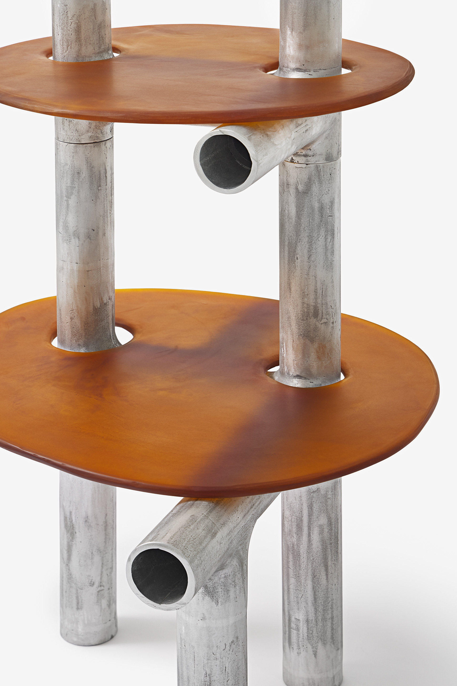 Cylinder Series by Jeonghwa Seo — A two-tier sculptural table from the Cylinder Series featuring weathered aluminium cylindrical supports arranged in a tripod configuration.
