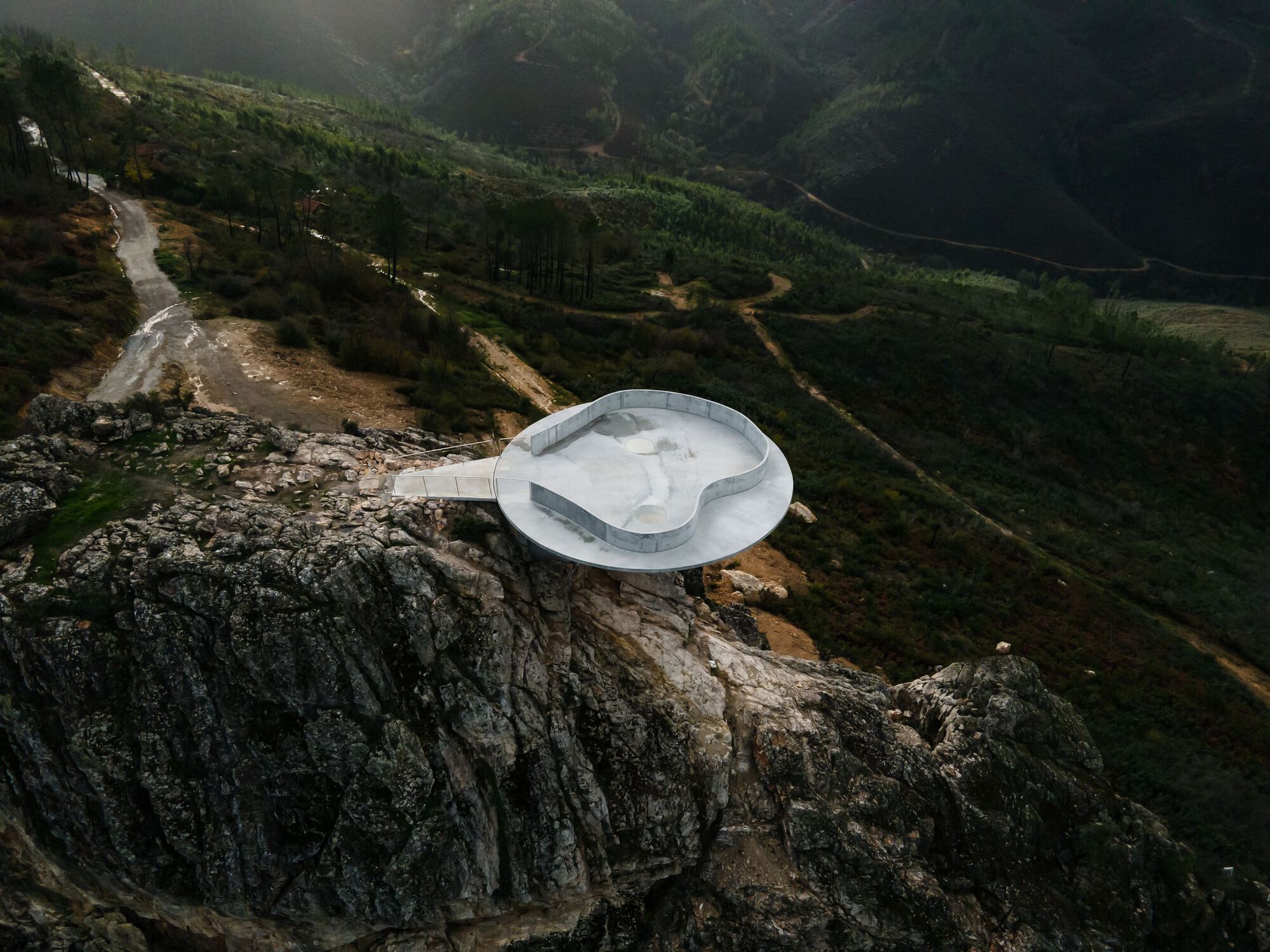 Renovation of the Zebro Viewpoint by Álvaro Siza Vieira by Alvaro Siza — Álvaro Siza Vieira's circular concrete platform cantilevers dramatically from the rocky stone base of Zebro Viewpoint, its white reinforced concrete form...