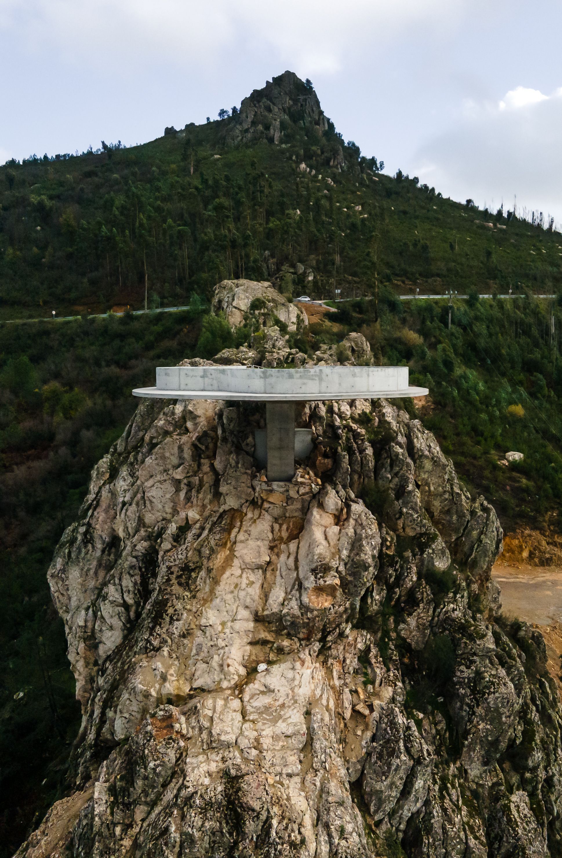 Renovation of the Zebro Viewpoint by Álvaro Siza Vieira by Alvaro Siza — Álvaro Siza Vieira's Zebro Viewpoint demonstrates structural clarity through a white reinforced concrete circular platform cantilevered from a weathered...