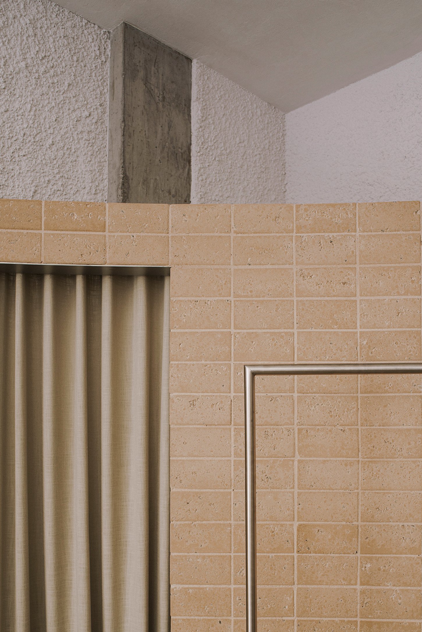 Neutrale by estudio DIIR — A corner detail of the Neutrale retail interior reveals the material hierarchy that defines the space.