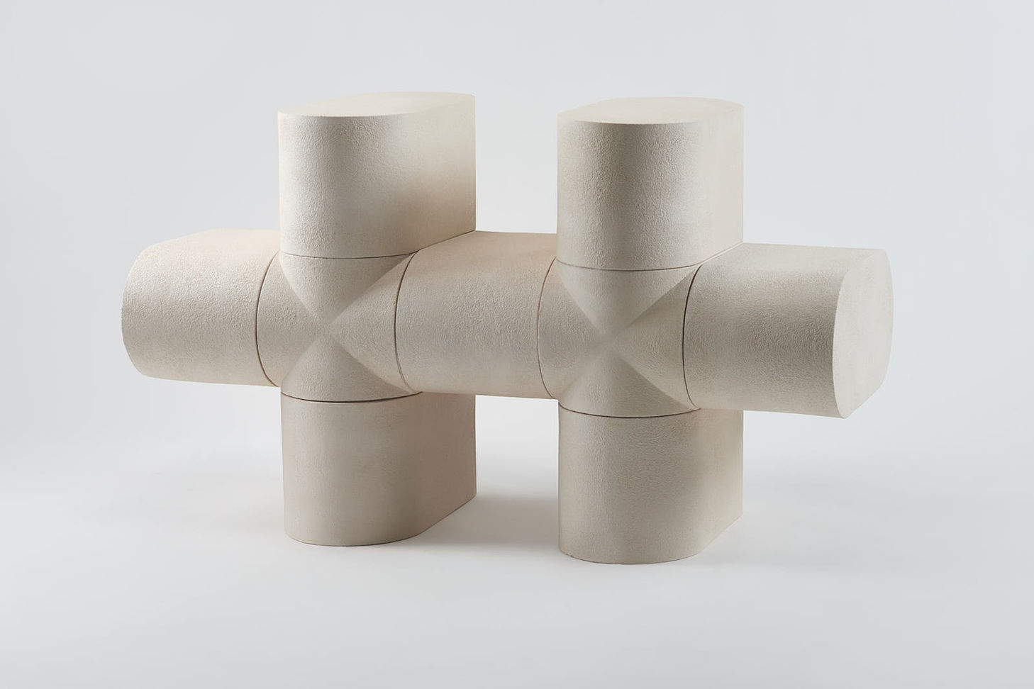 Modular Ceramics by Rino Claessens — Modular stoneware components arranged in a cross configuration, demonstrating the system's three-dimensional assembly capability.