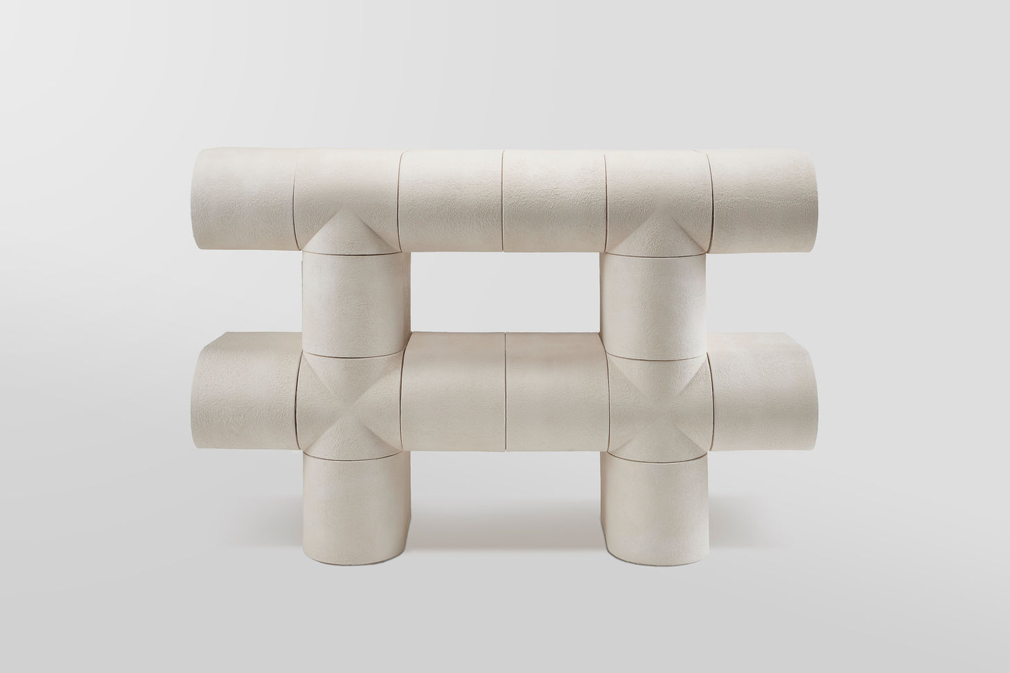 Modular Ceramics by Rino Claessens — Overhead view of a modular ceramic system composed of cylindrical and rectangular stoneware components arranged in a cross-axial configuration.
