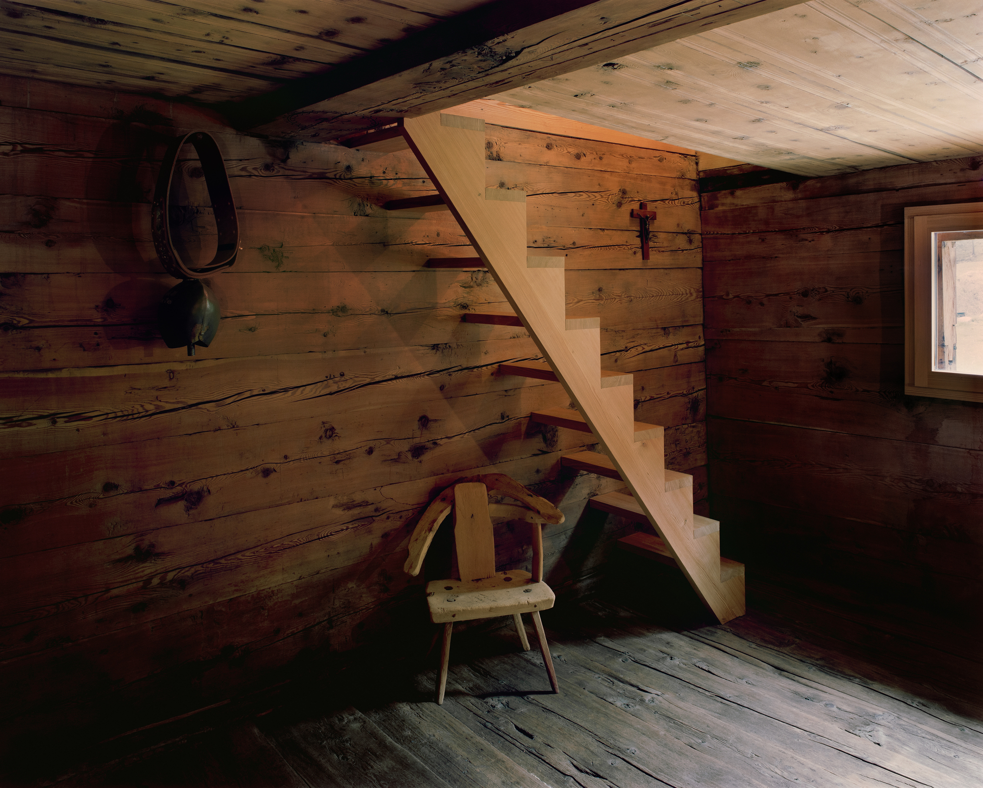 Lù Chatarme Transformation by Deschenaux Follonier by Deschenaux Architectes — Interior view of the transformed alpine chalet revealing the post-and-beam structural logic.