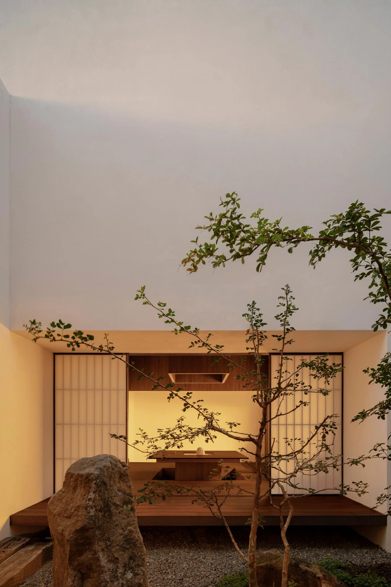 Kehai House by HW Studio, photographed by César Béjar, Gustavo Quiroz — A narrow interior passage frames a minimalist composition of raw materials and void.