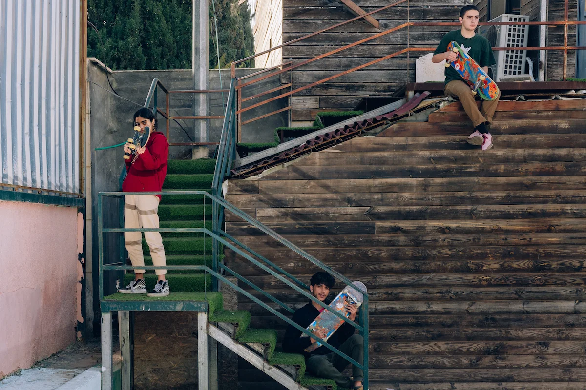 Landing by Maen Hammad, photographed by Maen Hammad — A cylindrical concrete watchtower illuminated by golden-hour light dominates the frame, its cylindrical form rising from a concrete plinth.
