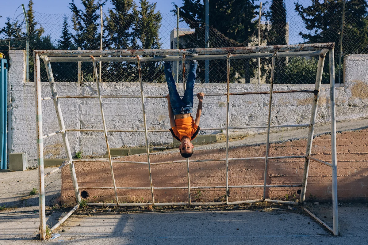 Landing by Maen Hammad, photographed by Maen Hammad — A surveillance and public address system mounted on a concrete block wall in the West Bank.