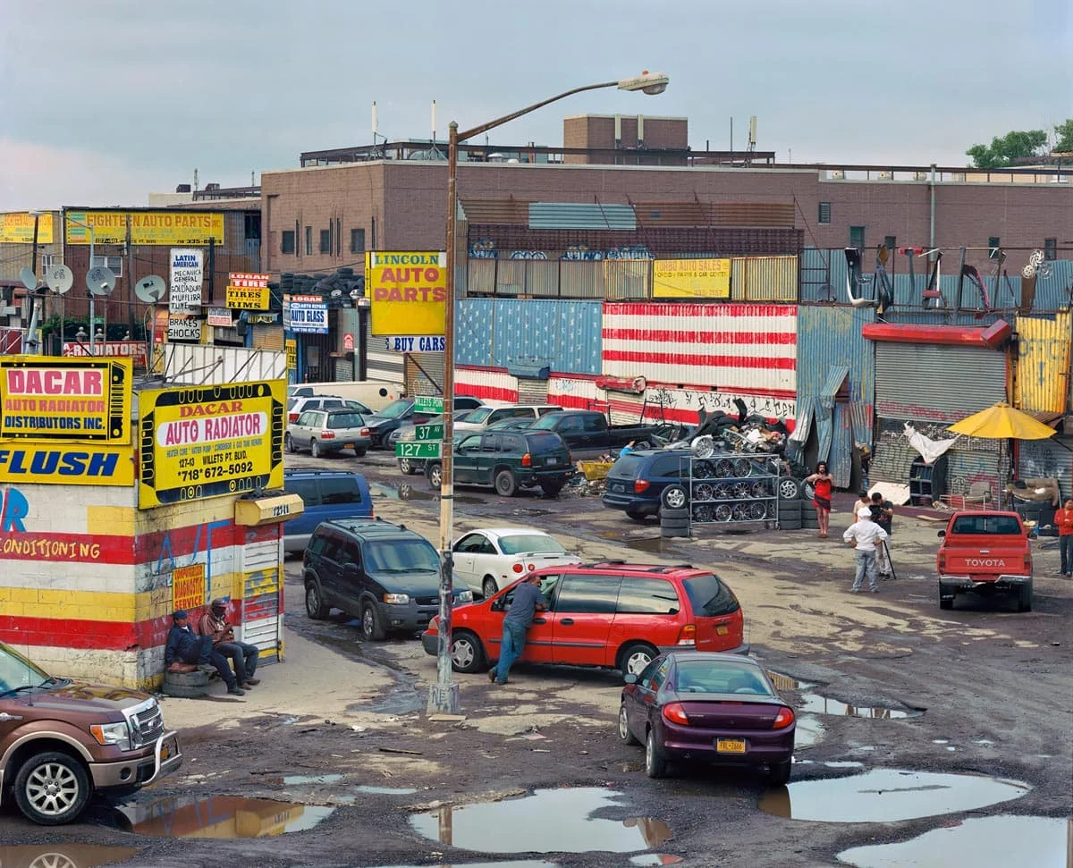 National Character by John Sanderson, photographed by John Sanderson — A turquoise-painted Greyhound bus station with matching vintage coach parked alongside, set against bare winter hills.