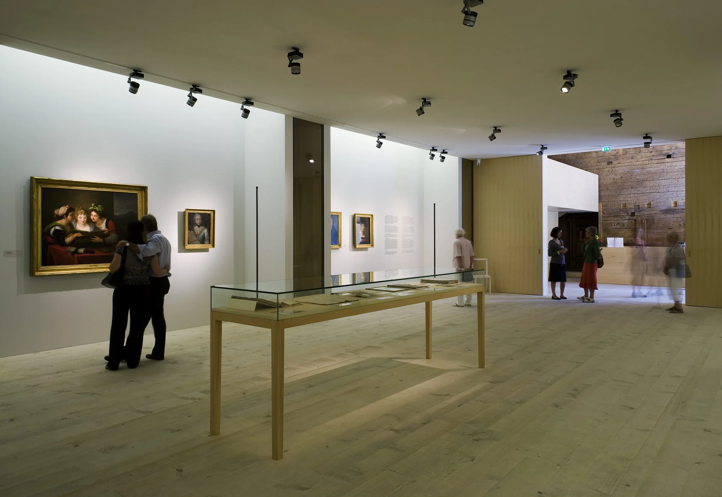 The Angelika Kauffmann Museum by Dietrich Untertrifaller, photographed by Bruno Klomfar — A gallery interior featuring light-wood flooring and track lighting recessed into a cream ceiling.