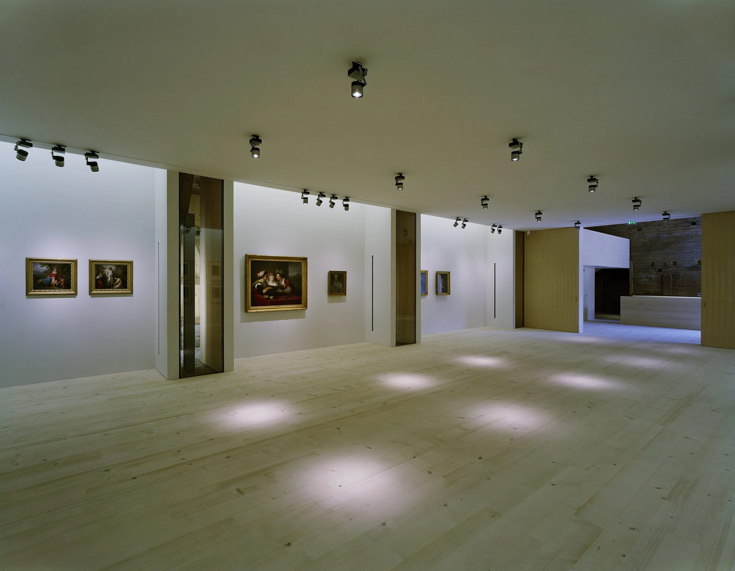 The Angelika Kauffmann Museum by Dietrich Untertrifaller, photographed by Bruno Klomfar — The gallery entrance frames a spacious interior with light pine flooring and cream-colored walls.