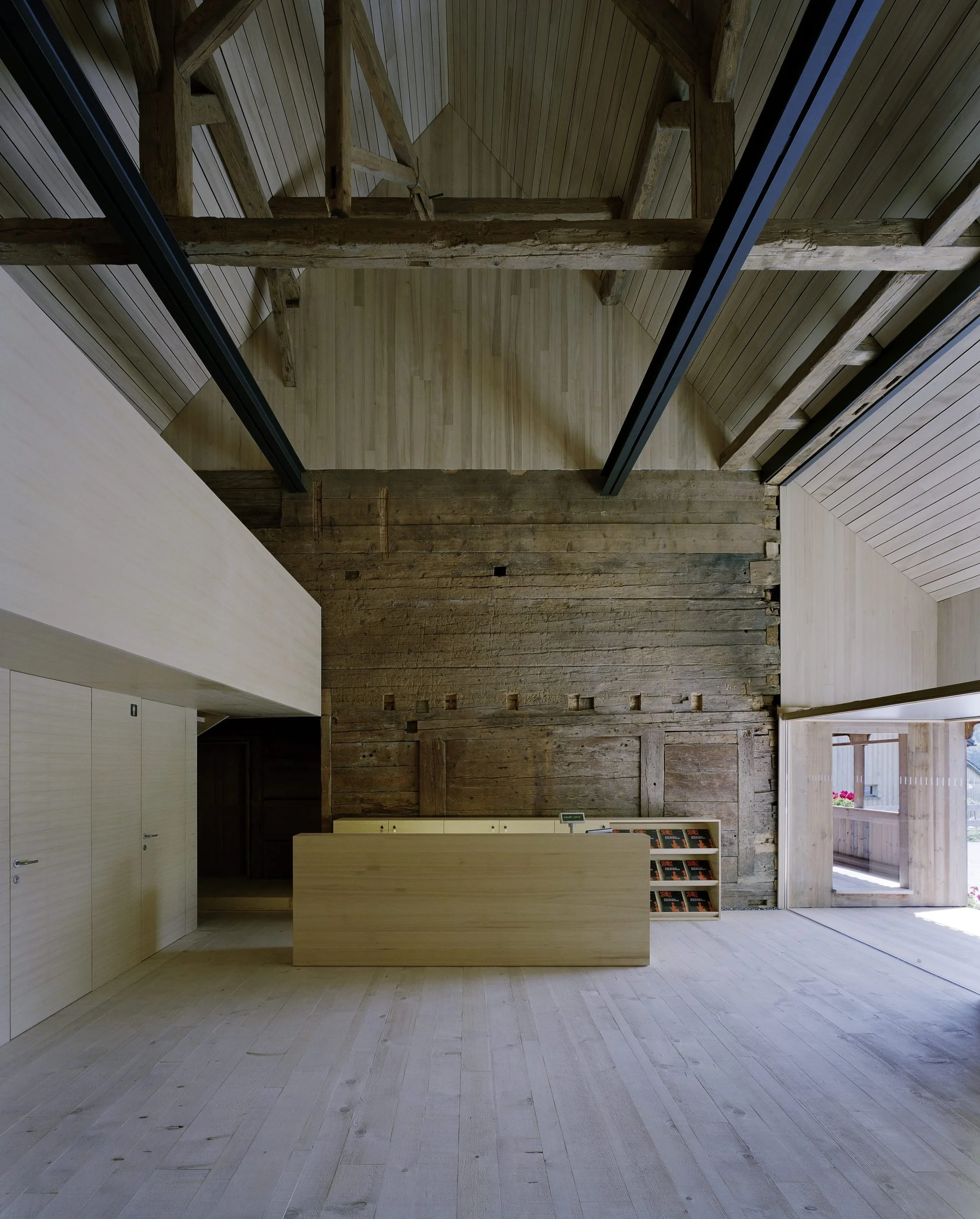 The Angelika Kauffmann Museum by Dietrich Untertrifaller, photographed by Bruno Klomfar — The museum's central gallery displays a double-height interior with exposed timber beam ceiling and whitewashed wood plank walls.