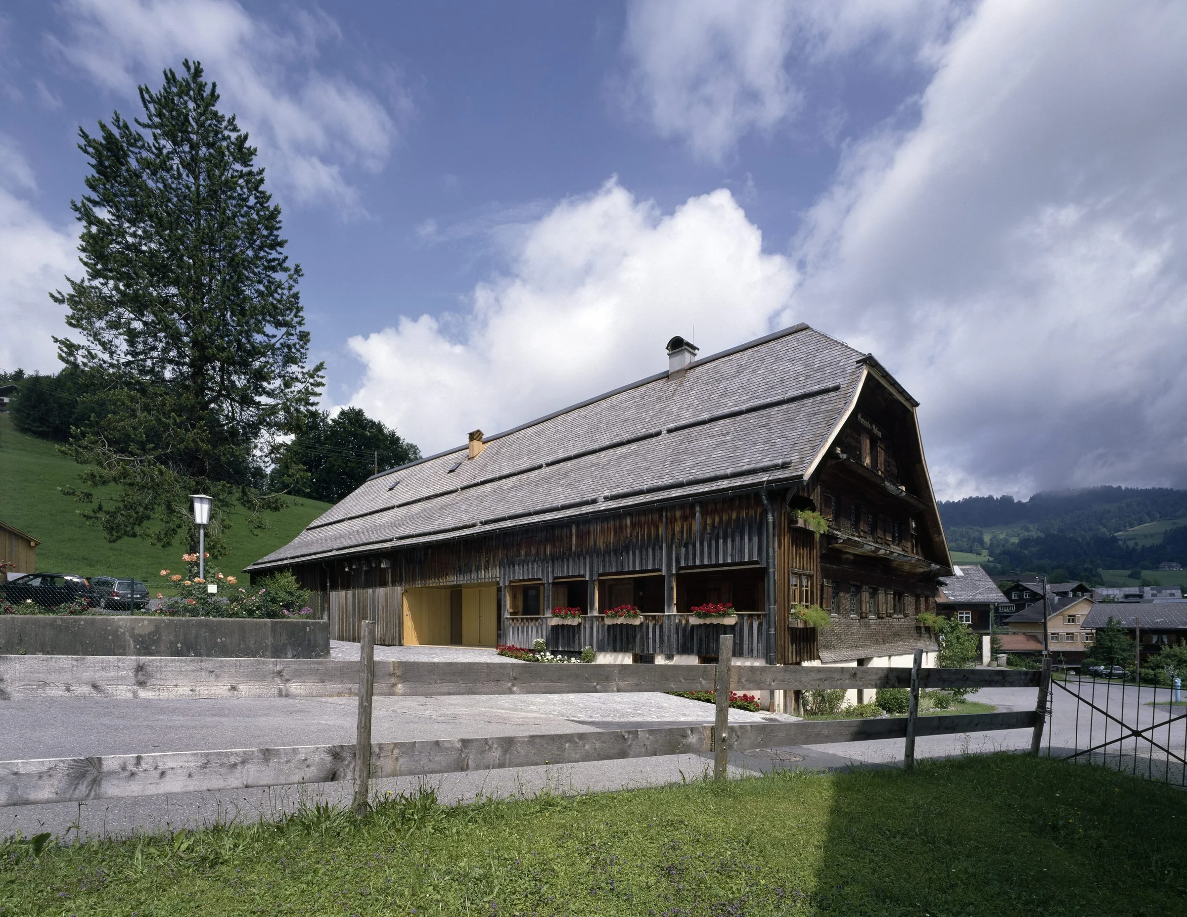 The Angelika Kauffmann Museum by Dietrich Untertrifaller, photographed by Bruno Klomfar — The Angelika Kauffmann Museum's street facade presents a carefully composed elevation of weathered timber cladding in vertical board-and-batten configuration.