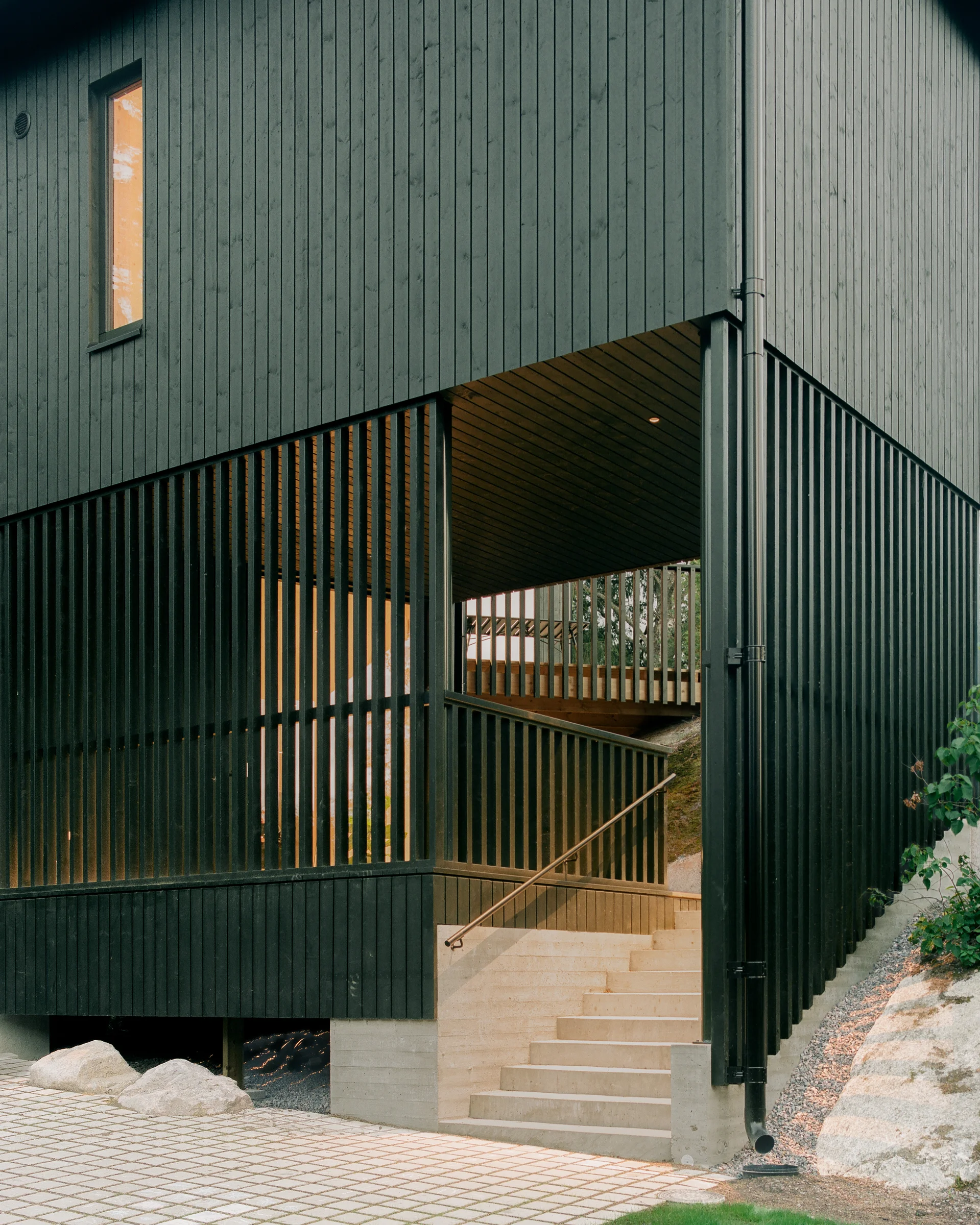 Villa Margo by Talli Ark, photographed by Kalle Kouhia — A children's bedroom clad entirely in light pine, with a pitched board ceiling and vertical wall paneling.