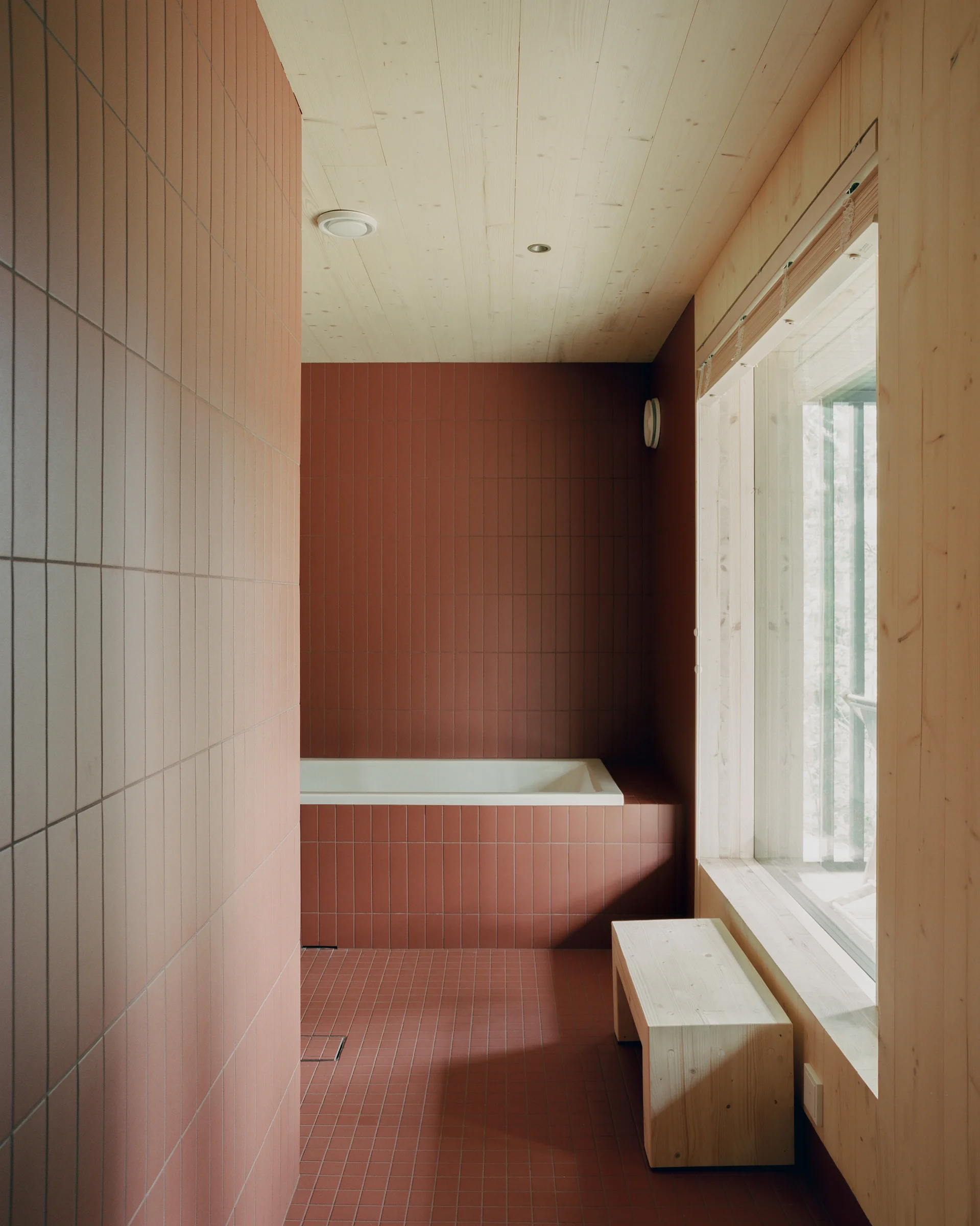 Villa Margo by Talli Ark, photographed by Kalle Kouhia — Kitchen threshold view into the dining and living spaces of Villa Margo.