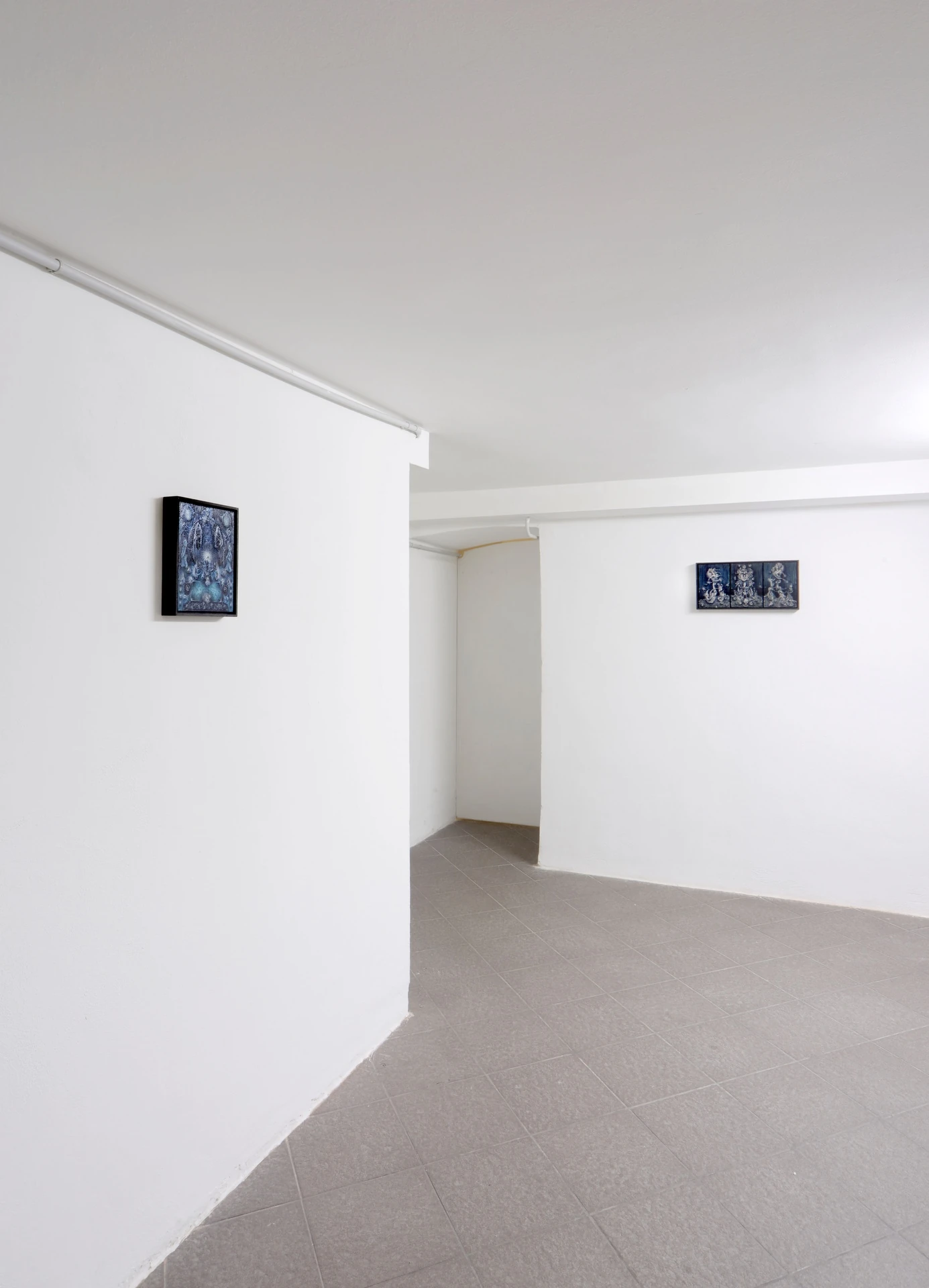 The Fire and its Ghosts by Andrea Luzi + Nicola Ghirardelli, photographed by Oscar Giacomini — Wall-mounted triptych of smaller panels with layered graphic marks, dense and glyph-like.