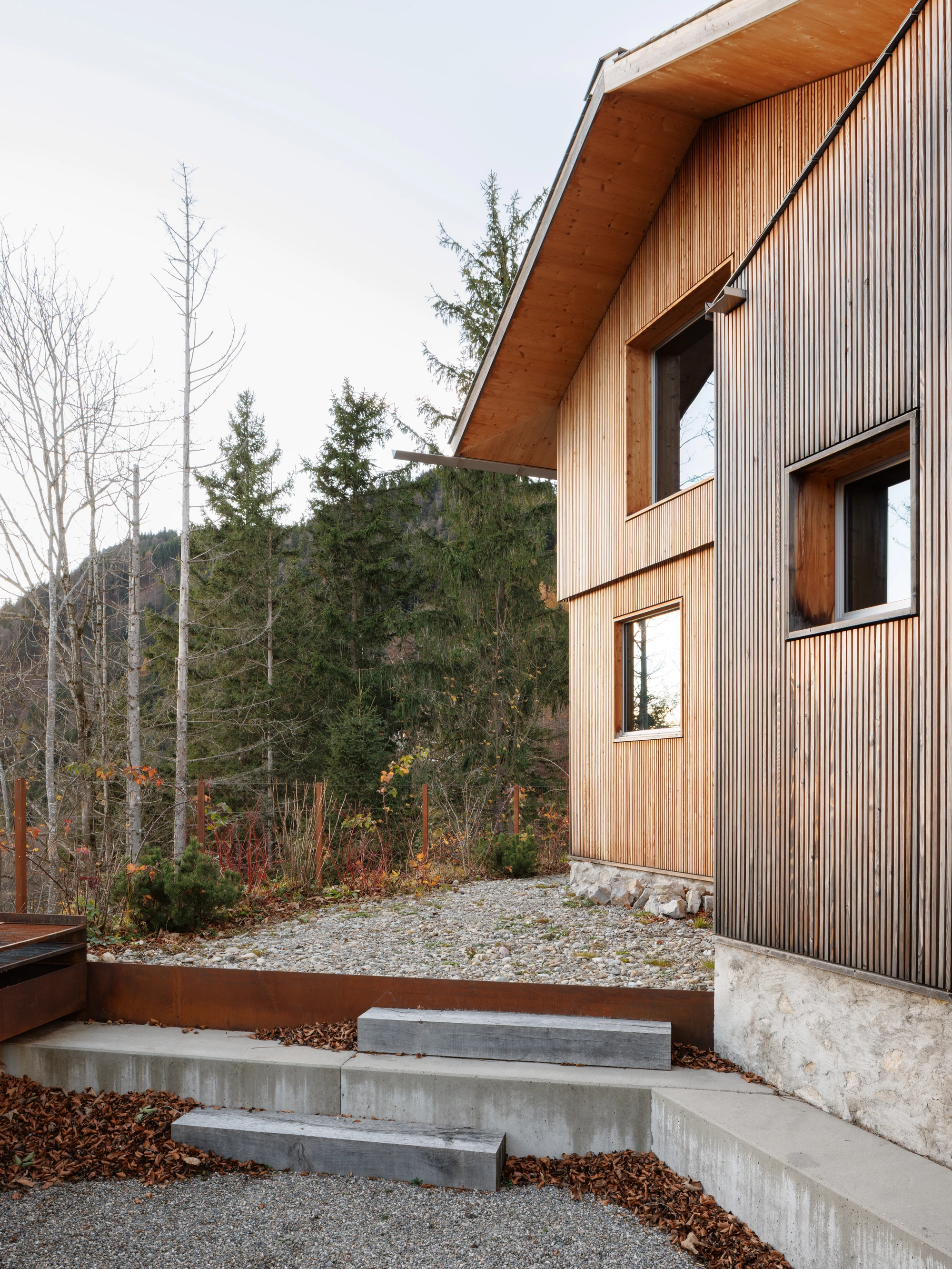 Swiss Alpine Cabin Reconstruction by Guča arch., photographed by Matej Hakár — Interior of the sleeping zone with sliding walls closed: CLT surfaces on all sides, a narrow light fitting above the headboard level.